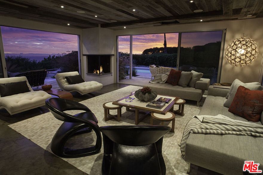 The panoramic views of the ocean, city, and mountains that will take your breath away. This sleek, simply stunning home has been redone and is fully furnished with high-end finishes. All rooms open to the magnificent yard, which offers various sitting areas for dining. The sparkling pool and spa overlook Catalina Island. The sun-filled living room has polished concrete floors, retractable glass doors, a corner fireplace, and an electronic drop-down projector and screen. The elegant kitchen, with Caesar stone counters, sub-zero refrigerator, Thermadore oven & wine cooler opens to the dining area with a large built-in banquet. The Primary bedroom has an attached office, enormous walk-in closet, and retractable doors, opening to expansive views.  The home recently passed air quality tests for asbestos, lead and soot/smoke.  The home is current leased until January 7th, 2026, and is available January 12, 2026 for a year or more, and will consider short term as well.