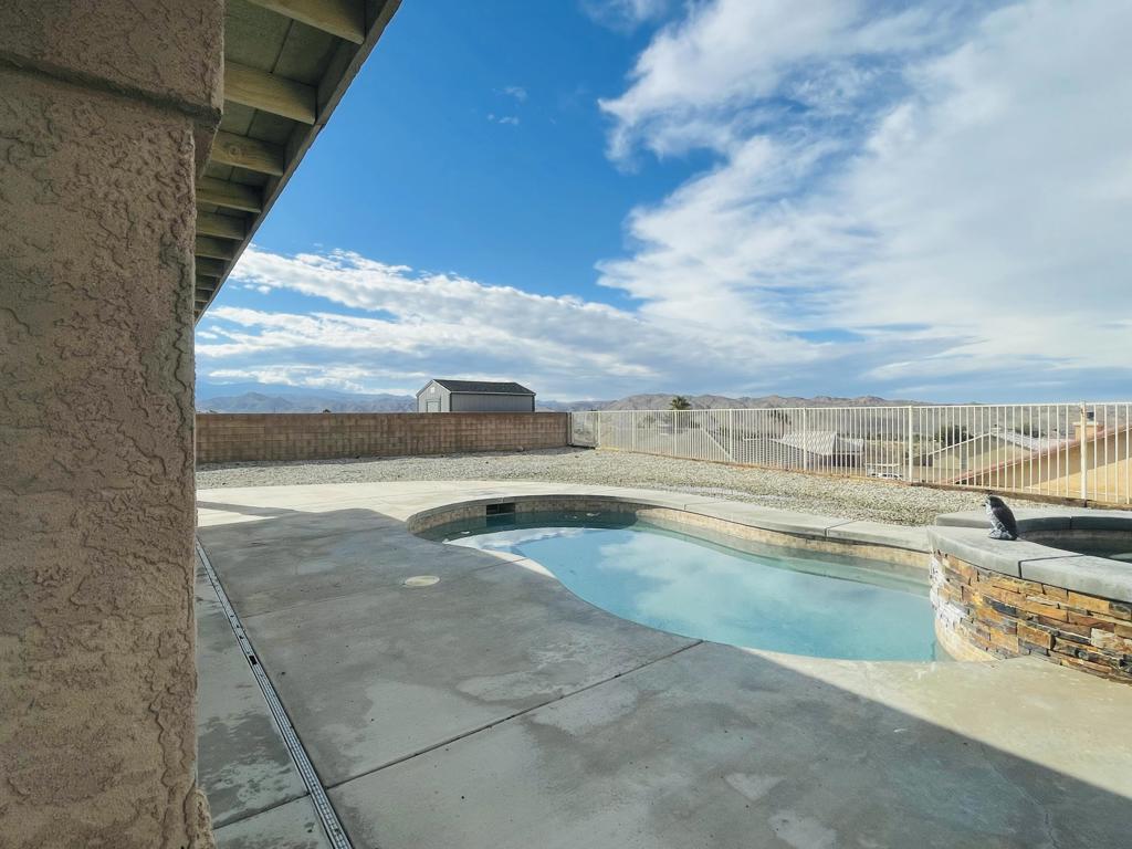 Welcome to 57088 Millstone Drive, where comfort, efficiency, and lifestyle all come together in the highly desirable Golden Bee area of Yucca Valley.This spacious home offers a rare 5-bedroom layout (including a bonus room, buyer to verify) -- perfect for large families, multi-generational living, or those needing extra space for an office or creative studio.Step outside and enjoy sweeping desert views from your private pool -- the perfect place to unwind and take in the sparkling night skies. Inside, the home features a freshly updated look with espresso-painted kitchen and bathroom cabinetry, creating a clean, modern feel that brightens each space.Key features include:Owned Solar System for significantly reduced electric billsBrand new AC unit & water heater for peace of mindBonus 5th bedroom flexibility (buyer to verify)Expansive outdoor living space with night views from the poolWhile fixtures reflect the home's original charm, thoughtful updates make it move-in ready and a strong foundation for adding your personal touch.Located in a sought-after subdivision with easy access to schools, shopping, and town conveniences, this home represents exceptional value under $550k in Yucca Valley.
