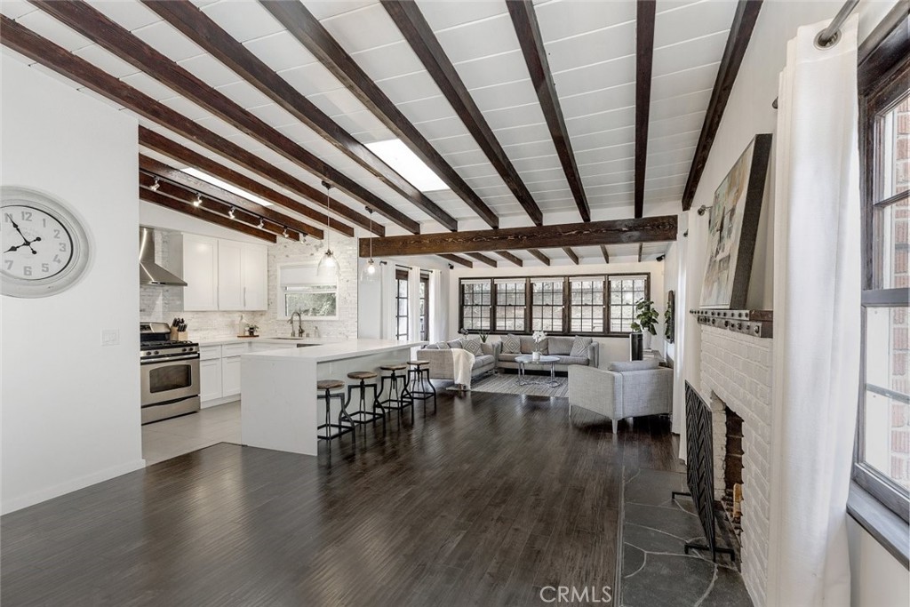 Welcome to this beautifully maintained 2-bedroom, 1-bathroom home with 1140 sq ft of living space in the desirable Tujunga area. The open-concept living and family rooms offer plenty of space for relaxation or entertaining. Large windows fill the space with natural light, creating a warm and inviting atmosphere throughout. The modern kitchen features stainless steel appliances, ample cabinet space, and a large kitchen island, perfect for cooking or casual dining. A cozy fireplace in the living room adds a welcoming touch, making the space even more comfortable. The dining area is separate and ideal for intimate gatherings, with contemporary finishes that highlight the home's charm. Throughout the home, you'll find stylish laminate flooring, creating a seamless flow from room to room. High vaulted ceilings provide an open, airy feeling that enhances the home's spaciousness.
Outside, the backyard is a peaceful retreat, surrounded by lush greenery. It's the perfect space for outdoor dining, gardening, or relaxing in the fresh air. With plenty of room to enjoy the outdoors, this backyard is sure to become a favorite spot. Located in a sought-after neighborhood, this home is an opportunity you won't want to miss.