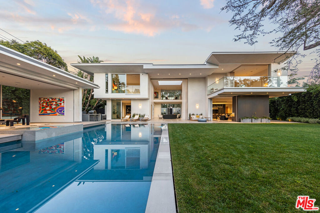 Located north of the famed Montana Avenue in Santa Monica, minutes from the beach, this exquisite contemporary estate exudes seclusion, wellness, and best-in-class design. New state-of-the-art construction, the property includes 7 bedrooms and 12 bathrooms across the main residence with a separate adjacent pool house. Heightened ceilings and dramatic walls of glass span the main level with a floor plan that seamlessly transitions from each room to the next, including the formal sitting room, separate family room, elite show kitchen, and a fully equipped industrial chefs-kitchen that leads into the formal dining room. Motorized doors open to the zero edge pool/jacuzzi exterior terraces and expansive lawn. This home offers best-in-class smart home technology system operated through voice activated Josh AI with all the amenities a buyer would hope for. Upstairs, a gracious primary suite takes advantage of the home's lush garden views while 3 more spacious ensuite bedrooms round out the floor. On the lower level, a resort-level spa/wellness center comes complete with an illuminated Himalayan salt wall, a redwood cedar sauna with oversized tropical rain shower with aromatherapy steam features, plunge pool, a meditation platform surrounded by a moat, and a massage therapy room. Added luxe features and details include, office, dual elevators, elite-level gym, multi-car garage, 1,157sf of basement flex space, and air and water purification systems. Intricate designer touches elevate the property such as Waterworks faucets and shower trims, Julien and Franke stainless sinks, European Oak floors, a Lynx pizza oven and grill, and artisan marble throughout. The estate is the ultimate combination of elegance, style and functionality. One of the most exclusive compounds to ever hit the market in Santa Monica.