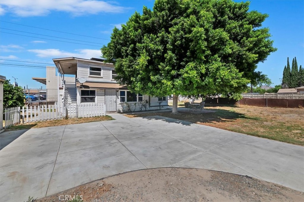 Welcome to this versatile duplex, offering two stacked units with private entry via an exterior staircase. The main level boasts a comfortable 2-bedroom, 2-bathroom layout, while the upstairs unit features 1 bedrooms and 1 bathroom—perfect for extended family, guests, or rental income. Each unit offers bright and functional living spaces with classic kitchens and cozy rooms, providing endless potential for personalization and modern upgrades. Set on an expansive lot, the property showcases a long driveway, a wide open front yard, and a charming side/rear porch ideal for relaxing outdoors. With its flexible design, this duplex presents a wonderful opportunity for multi-generational living, income-producing potential, or crafting an investment property with incredible upside.