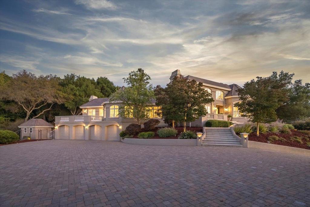 Perched high in the coveted Saratoga Hills at the end of a private cul-de-sac, this gated architectural masterpiece showcases panoramic views from the shimmering waters of Alviso Bay to lush vineyard valleys. Timeless elegance meets contemporary sophistication, with walls of glass framing sweeping skylines, glittering city lights, and sunsets rivaling world-class resorts. Expansive terraces invite you to hear music from the renowned Mountain Winery and watch vineyards transform with the seasons. Designed for privacy, security, and grand entertaining, the estate offers a gated entry, discreet fencing, and a driveway for 10+ cars. Inside, custom millwork, gleaming floors, and artisan glass set the stage for grand rooms, intimate lounges, and panoramic terraces. The gourmet chefs kitchen with premium appliances and a butlers pantry anchors the home, while the luxurious primary suite boasts a spa bath and private balcony. Multiple guest suites, a home office, theatre, gym, and game rooms provide versatility. Resort-style grounds include a sparkling pool, spa, and multiple terraces perfect for sunset cocktails or weekend celebrations with room for a cabana, gardens, or vineyard. A once-in-a-lifetime opportunity to live, entertain, and thrive at the summit of Silicon Valley.