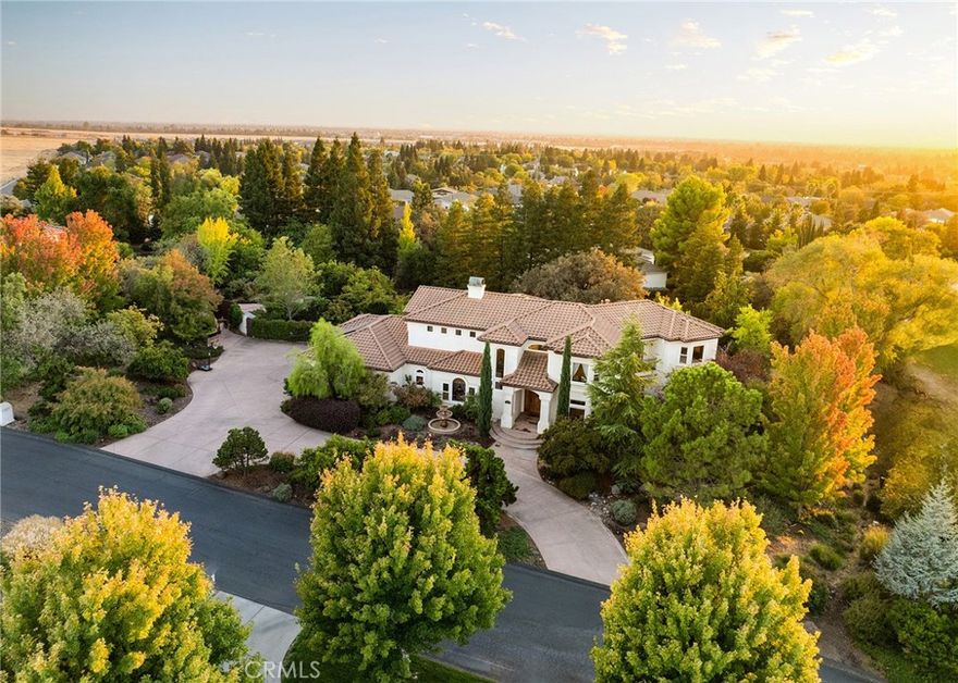 Welcome to a truly remarkable estate within the highly sought-after gated community of Canyon Oaks. Nestled on a private cul-de-sac on a sprawling one-acre lot near the entry gate, this Spanish-inspired residence showcases breathtaking landscaping and elegant design elements throughout. Step through the grand entryway into a home that exudes sophistication, with arched walkways and expansive windows that flood each room with natural light and offer beautiful views of the meticulously crafted grounds. The living room is an entertainer's dream, boasting soaring high ceilings, a cozy fireplace, and seamless flow into a gourmet kitchen. Here, you'll find luxurious granite countertops, double ovens, stainless steel appliances, an island and peninsula, plus a charming dining nook. Additional features on the main level include a climate-controlled wine storage room, two guest bedrooms, two guest bathrooms (one with a relaxing sauna shower), a formal dining room, and a cozy library with its own fireplace. Ascend the stunning wrought iron staircase to a second-floor terrace that overlooks the main living area. The upstairs media room provides a versatile space for entertainment or relaxation. The primary suite is an expansive retreat, featuring a fireplace, skylights, a private reading area, a balcony with scenic views, and a massive walk-in closet. The luxurious ensuite bathroom offers a soaking tub, walk-in shower, double sinks, and a vanity area. Upstairs, you’ll also find two additional guest bedrooms and a full guest bathroom. The backyard is an absolute oasis with a lush lawn, a stunning pool, a serene koi pond with a flowing stream, a hot tub and outdoor shower, and a garden area surrounded by mature fruit trees. This dream yard is perfect for both relaxation and recreation. Other premium amenities include an on-demand water heater, an EV charger, 50 owned solar panels with backup batteries, three HVAC units, a whole-house vacuum system, extensive storage space with both basement and attic areas, and an oversized three-car garage. This home truly has it all – an unparalleled blend of luxury, privacy, and functionality.