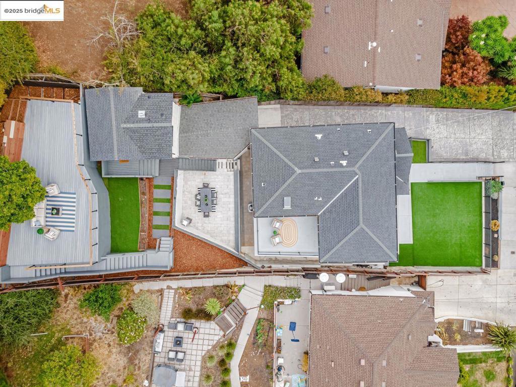 This beautifully reimagined property has been lovingly transformed into a stunning single-family home with a bonus studio, offering 5 bedrooms and 4 bathrooms. Every detail inside and out has been thoughtfully crafted. The main level opens with a sunlit living room, anchored by a sleek elongated fireplace, leading to the gourmet kitchen with sparkling white cabinetry, gold hardware, high-end appliances, dazzling light fixtures, and an expansive breakfast bar. Two dining spaces—formal and casual—make gatherings effortless. Also on this level are two spacious bedrooms, each with its own stylishly upgraded bathroom. The floor plan flows seamlessly to both the charming front yard and landscaped backyard. Upstairs, the primary suite is a private retreat with serene views, a balcony, and a spa-inspired bath with soaking tub, separate shower, and dual vanities. A second master suite provides equal comfort and sophistication, ideal for guests or extended family. The fully functional studio features its own updated kitchen, bathroom, and views, perfect for rental income or guest use. Outdoors, multi-level decks offer entertainment and relaxation, while tasteful fencing, new pavement, garage, and income potential make income potential make this home complete.