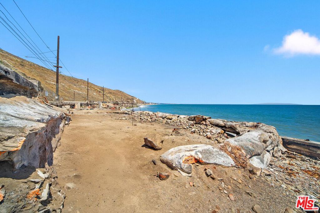 An exceptional opportunity to build your custom beachfront retreat on the sand in Malibu. Located on Las Tunas Beach with 28 feet of frontage, this Palisades fire lot offers sweeping views of the Queen's Necklace, Palos Verdes, and Catalina Island - just minutes from Santa Monica. Phase 1 and 2 debris clearance has already been completed, and the lot may be eligible for the expedited fire rebuild process with the potential to increase the previous home's square footage by up to 10%, subject to buyer verification. The prior home was a remodeled two-story single-family residence featuring 2 bedrooms, 3 bathrooms, 1,684 square feet, an oceanfront deck, a rooftop deck, a 2-car garage, and direct access to the sand. This is a rare blank slate offering endless potential to reimagine Malibu beach living in a prime location.