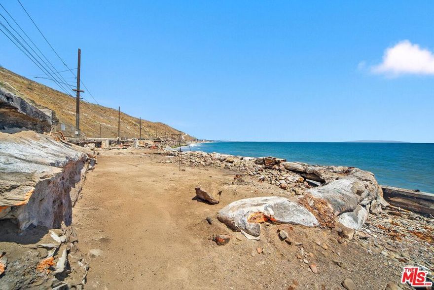 An exceptional opportunity to build your custom beachfront retreat on the sand in Malibu. Located on Las Tunas Beach with 28 feet of frontage, this Palisades fire lot offers sweeping views of the Queen's Necklace, Palos Verdes, and Catalina Island - just minutes from Santa Monica. Phase 1 and 2 debris clearance has already been completed, and the lot may be eligible for the expedited fire rebuild process with the potential to increase the previous home's square footage by up to 10%, subject to buyer verification. The prior home was a remodeled two-story single-family residence featuring 2 bedrooms, 3 bathrooms, 1,684 square feet, an oceanfront deck, a rooftop deck, a 2-car garage, and direct access to the sand. This is a rare blank slate offering endless potential to reimagine Malibu beach living in a prime location.