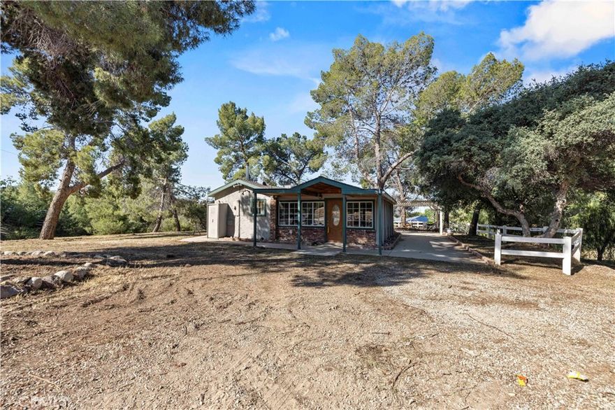 Imagine the night sky full of stars. This secluded Agua Dulce property spans just over 2.5 acres. The mostly usable acreage offers privacy as well space to build your own horse corrals or ADU. There are additional buildings for storage or whatever you may need!. The 3,000 sqft temperature controlled workshop is currently equipped with 20 dog kennels.  There is RV hook ups and 220V in the shop!