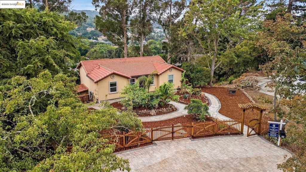 Approximately 2,400 square feet of living space on a huge and private 0.35-acre lot. This charming house features an inviting entryway, lush landscaping, and scenic views. The open floor plan offers abundant natural light and vaulted ceilings, creating a spacious and airy atmosphere. The hardwood floors throughout add warmth and elegance. The primary bedroom is spacious with an elegant vanity and tiled shower in the in-suite bathroom. Three additional bedrooms, one on the upper level and three on the lower level, provide ample room. The kitchen is large and open, with a huge layout that takes advantage of the 180-degree views both up and down. The property also boasts a spacious deck and a scenic backyard with lush natural greenery. Other notable features include a paved walkway, four off street private parking and a beautiful artistically designed fencing. A charming exterior, and a wrap-around double deck. The home has been meticulously updated with custom tilework, a tile roof, and a split-zone heating and air conditioning system. This home only comes once in a life time! Worth a visit. Direct 3D tour viewing: https://my.matterport.com/show/m=3p5XMEh33j6
