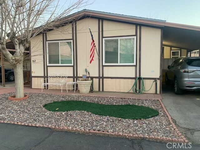 WITH THE LOWEST SPACE RENT IN APPLE VALLEY, AND A MOST LUXURIOUS HOME FEEL, YOUR DREAM HOME AWAITS YOU!!! A TRUE GEM!!! LOTS OF UPGRADES!! HUGE STORAGE SHED AND AMPLE SIZED BACK YARD!! Tucked within a gated, 55+ senior community in Apple Valley, this charming two-bedroom, two-bath double-wide invites you to settle into desert living with ease and warmth. Mature shade trees stretch their branches over a brick-paved patio and covered carport, creating a private outdoor space that’s ideal for morning coffee, evening BBQs with friends and family, or simply soaking in serene mountain and desert views. Inside, warm wood tones, a beamed ceiling and plantation shutters cast soft light across comfortable floors with wood-look surfaces blended for cozy yet elegant style. Thoughtful details like a chandelier above the dining area and a china cabinet create an inviting sense of home. The gentle hues echo the nearby Mojave, blending comfort with a natural desert palette. The primary suite is a restful retreat featuring a spacious mirrored closet. and an upgraded bathroom with a walk-in shower—designed for accessibility and comfort. The second Bathroom is equipped with a shower-tub combo, perfect for quick showers or soothing soaks. The fully remodeled kitchen is the heart of the home! It shines with granite countertops, all-inclusive gleaming stainless-steel appliances, and thoughtful finishes—ready to inspire your favorite baked treats, casual or gourmet meals! Washer and dryer are included, tucked into a spacious utility room complete with cabinetry and shelving. Lots of outdoor charm with the carport or side-porch entry, step into the heart of your home—then out to the brick patio, shaded by a welcoming canopy of mature trees. A durable chain-link fence creates a safe haven for pets or grandchildren, while a handy, huge storage shed offers space for tools, gear, or garden treasures. With the sun dancing across distant mountain ridges, you'll find this outdoor nook is equally lovely at dawn and dusk. The neighborhood is pet-friendly, so your four-legged companions are warmly welcomed too. If you're seeking a relaxed, comfortable desert retreat tailored for active seniors, this home offers precisely that—where everyday living blends seamlessly with shaded outdoor spaces and community-centered amenities. Pool and recreation room for parties or family gatherings. Call today for a private tour. This is the jewel you've been seeking!