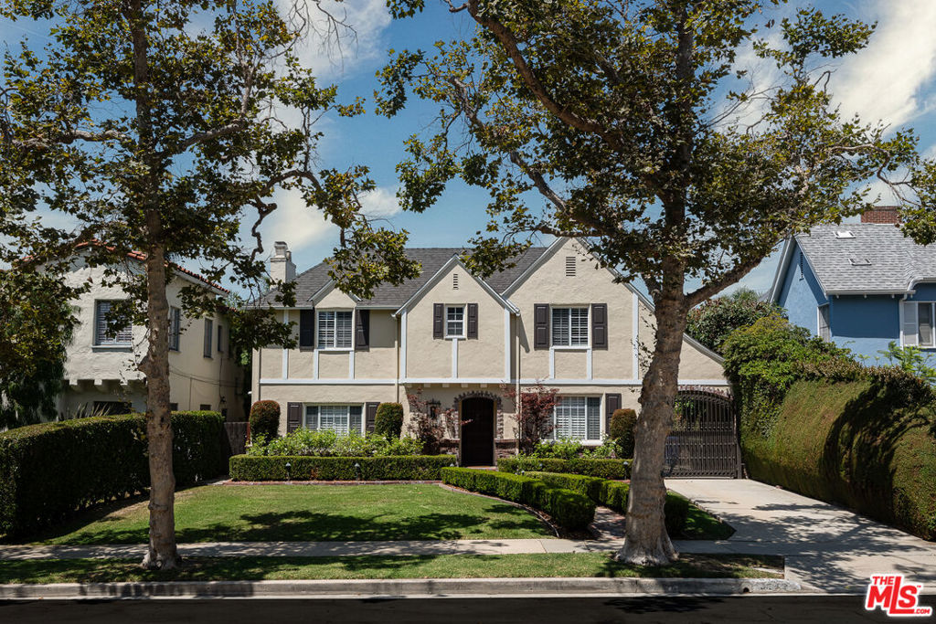 Beautifully renovated, 1926 English Tudor in Hancock Park! This property is designed for entertaining and offers sophisticated and stylish living. The inviting entry foyer leads to a step-down formal living room featuring a beautiful wood-beam ceiling and a decorative fireplace. This stunning residence underwent a major renovation in 2015. The gourmet custom kitchen is bathed in natural light and includes a large breakfast area with custom cabinets, a Thermador fridge and freezer, a Viking oven/stove top, a new Miele dishwasher, and an extended island. The large family room with a wet bar opens to the outdoor entertaining area. The private, landscaped backyard features a large sun deck, perfect for relaxing or outdoor dining.The second floor boasts four generous bedrooms, including a luxurious master suite with a walk-in closet, overlooking the backyard with a pool, spa, and guest house. Additionally, there is a large laundry room for your convenience.