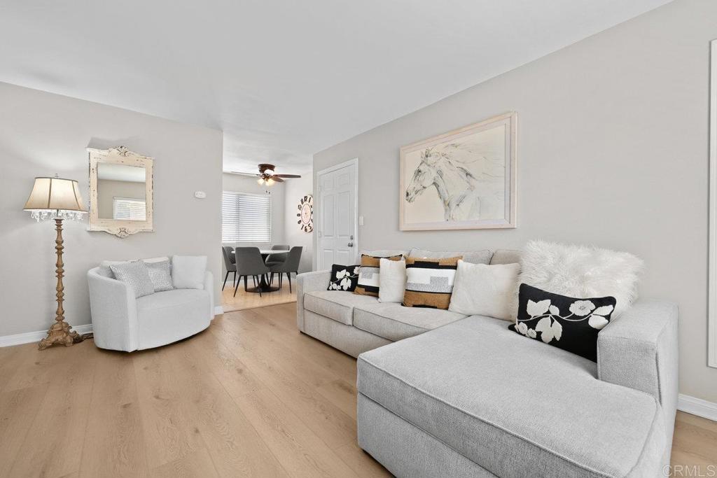 Experience comfortable, low-maintenance living in this updated 1BR/1BA condo located in the desirable Winter Gardens Terrace community. Featuring newer luxury plank flooring and fresh interior paint, this open-concept unit is filled with natural light. The kitchen offers travertine tile flooring, granite countertops, and newer stainless steel appliances. The spacious bedroom includes a large walk-in closet, and ceiling fans in the dining area and bedroom add year-round comfort. A brand new walk-in shower was just recently installed and dual-pane windows throughout enhance energy efficiency. Includes one assigned carport parking space (#92). Low HOA covers water, trash, sewer, and common area maintenance. Community amenities include a remodeled laundry facility, swimming pool, and ample guest parking. Convenient location near shopping, dining, and freeways (67, 8, and 52). VA & FHA approved!
