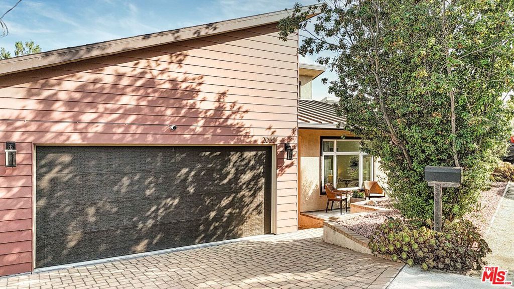 Perched on top of the hills of Elysian Heights is this light-drenched contemporary home with stunning city and hillside views. Built in 2016, this clever home offers all of the modern and convenient features you could need. Features begin with vaulted ceilings, a gas fireplace, and an entertainer's kitchen with a large center island in the generous open concept main living space. The living room, kitchen, full bathroom, bedroom/office/home gym are all on the street level while three bedrooms and two bathrooms are downstairs, offering a reverse-type floor-plan. The entryway opens into this beautiful space and through the living room, one can open the retractable glass wall system to a balcony featuring views of the Elysian Heights hills, Downtown Los Angeles, evening city lights and even the fireworks of Dodger Stadium. Downstairs, the primary suite features a walk-in closet, large glass surround shower, and French doors that open to an expansive deck. Beyond the back deck, you'll find a sparkling built-in spa, modern fire-pit, and patio space. Enjoy BBQs with the built-in outdoor kitchen and grow your own herbs, veggies and fruit in the additional garden space. This home is both comfortable and impressive, practical and fun. Work from home in one of the bedrooms that can double as a home office, or be able to have the perfect guest space on the main level for family and friends. Central HVAC system with an additional dual mini-split system for the living room and primary bedroom provides an energy-efficient climate control option. Attached two-car garage equipped with a 240v plug for EV car charging. Enjoy the convenience of nearby fine and casual dining, grocery stores, hiking trails, and local entertainment.