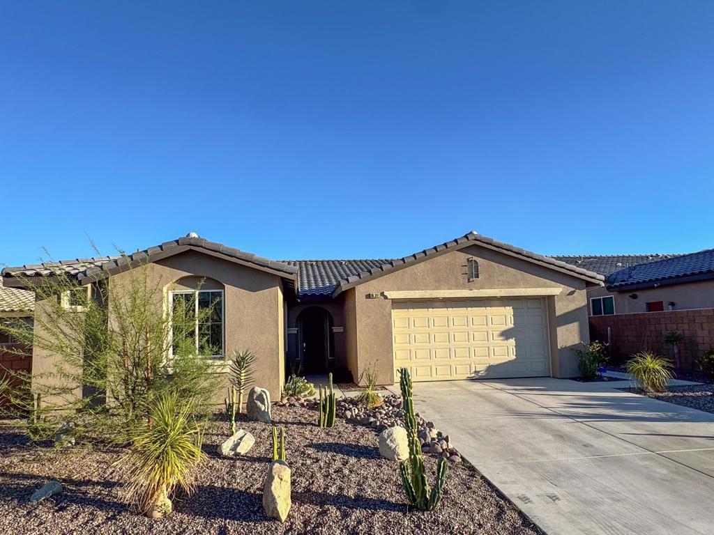 Gorgeous move in ready 4 bed, 3 bath pool home, built in 2022 and located in the gated Agua Dulce community. This home offers great curb appeal with mountain views, Owned Solar Panels, attached 2-Car Garage. The interior features an open floor plan with high ceilings, recessed lights, a fresh custom paint scheme, vinyl plank flooring throughout. The fabulous kitchen has quartz counters with breakfast bar seating, pendant lights over the breakfast bar area, tile backsplash, stainless steel appliances, and a pantry. The large primary suite also offers a private door to the backyard and a spa-like ensuite with full-size walk-in shower, dual vanities, and a walk-in closet. The 3 secondary bedrooms are on the opposite side of the home off of the entry hall two with a jack and jill bathroom. Enjoy the private backyard with built-in covered patio and with a private pool and spa! Sellers spent $75,000 on the new pool and spa as well as on landscaping and hardscaping! This is the perfect space for relaxing and entertaining! The community also offers a large pool and spa, and offers low HOA fees. This home is conveniently located not far from schools, shopping, dining, Palm Springs airport and more! Schedule a visit today before its gone!