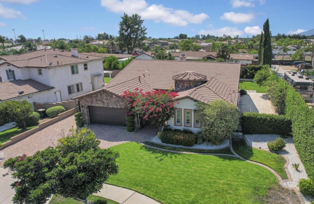 Welcome to this impeccably upgraded 5BD/4BA executive home located in a peaceful cul de sac in Rancho Cucamonga. Step inside to find luxurious 8-inch plank hardwood floors, soaring 12-foot ceilings with crown molding, and tasteful wainscoting throughout. The heart of the home is a designer kitchen featuring granite countertops, a generous island, stainless steel appliances including a double oven, and abundant cabinet space. It flows seamlessly into a spacious family room highlighted by a marble mosaic fireplace and a built-in media niche. The primary suite is a true retreat, offering a stunning spa-inspired bathroom with mosaic marble flooring, a freestanding clawfoot tub, an oversized marble shower with frameless glass, and a custom vanity. The nearly 12,000 square foot lot offers RV access with 220V power, and a large covered patio perfect for gatherings or quiet evenings outdoors. The backyard offers endless potential for a pool, play area, or garden. Built in 2003 with high-quality stone and stucco construction and a tile roof, this single-level home also features a two-car attached garage, gated RV parking and a security system. Short distance to freeway, shops, schools and more, this is a rare opportunity to own a truly turnkey luxury home in one of Rancho Cucamonga's most desirable neighborhoods.