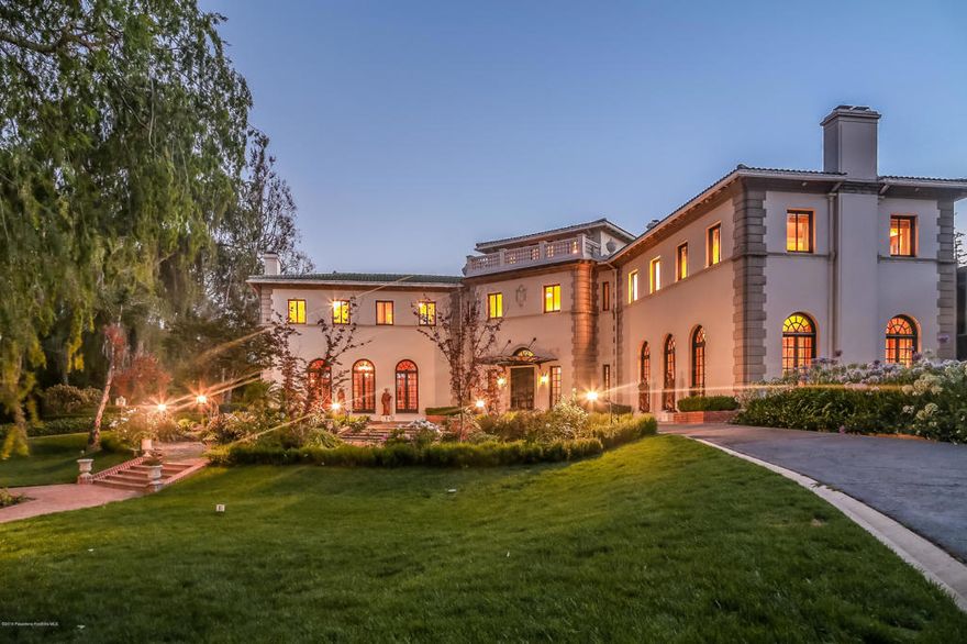 Located in the prestigious estate area in San Marino, this premier Italian Palladian Villa is designed by architect Robert D. Farquhar, who also known for his work on the California Club and The Pentagon. This gated property is elegantly appointed with a marble foyer, walnut paneled oval library, stately living room, formal dining hall, gym, solarium and elevator. The circular staircase leads to a children's play room, 6 bedrooms and the master suite complete with a boudoir. The park-like grounds feature a tennis court, pool & spa, mature landscaping, reflection pond, and guest apartment. With most of its original architectural elements intact, this estate is reminiscent of a bygone era of opulence and fine living.