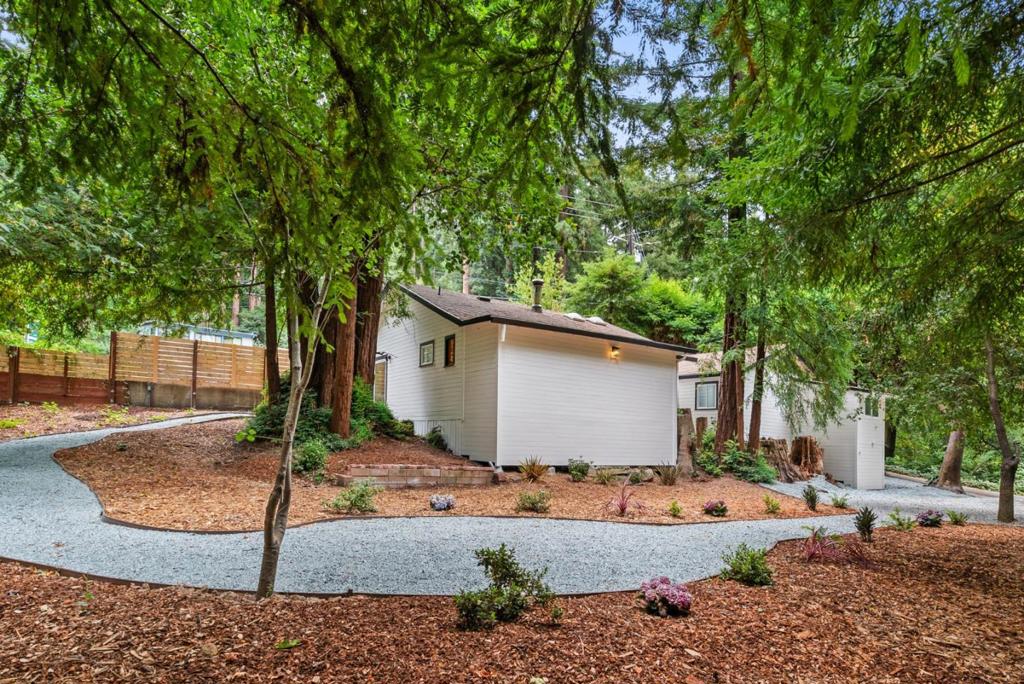 Charming remodeled retreat with expansive yard. Just 1.5 miles from downtown Boulder Creek, this beautifully remodeled 2-bedroom, 2-bathroom home offers the perfect blend of modern comfort and mountain tranquility. Nestled on a peaceful lot, it features a spacious open-concept layout, high-end finishes, and thoughtful updates throughout. At the heart of the home is an oversized kitchen with butcher block countertops, brand-new appliances, a large pantry, and plenty of space to cook, gather, and entertain. The generous living room is filled with natural light from the large windows, creating a warm and inviting atmosphere. The serene primary suite provides a restful escape, while the guest bedroom includes its own stylish en suite bath ideal for guests or flexible living arrangements. Step outside to a sprawling open yard with endless possibilities - garden, entertain, or simply unwind and enjoy the natural beauty that surrounds you. Whether you're looking for a full-time residence or a weekend getaway, this turnkey home delivers the best of both worlds. Enjoy easy access to Silicon Valley and the beaches of Santa Cruz, with world-class hiking and biking just minutes away at Big Basin and Castle Rock State Parks.