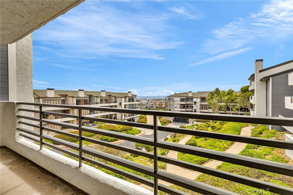Wake up in Paradise! Spacious ocean view living at the full service gated Villa Balboa community, minutes from the beach. This recently remodeled 2 bedrooms (an oversized master bedroom and a guest bedroom), 2 bathrooms (double vanity master bath and guest bath) condo has accent woodwork throughout (sailing vibe), recessed lighting, crown molding, carpet, hardwood, and tile flooring throughout. The kitchen has been remodeled with granite counter tops and stainless-steel appliances, and has a breakfast bar to complement the kitchen. Oversized balcony with storage closets and ocean views. The unit also has 2 assigned covered parking spaces in the underground garage. This quiet gated community offers a spacious clubhouse, two pools and spas, tennis courts, and a community fitness center. Sunset Ridge Park is within walking distance and the beach is just a few steps away. Ideal for sunrise and sunset walks. The sound of late night waves is soothing beyond description...