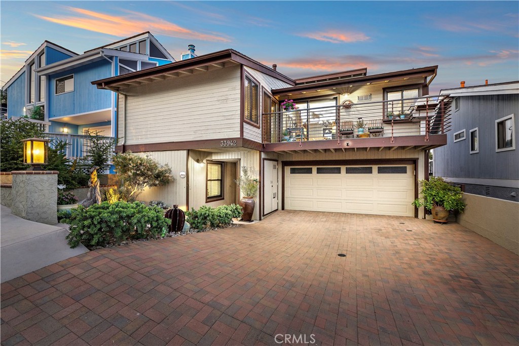 Welcome to 33942 Pequito Drive, where coastal living meets everyday convenience in the highly coveted Lantern Village. This beautifully upgraded 4-bedroom, 3-bathroom home spans 2,357 square feet and offers unparalleled ocean views from both sides and every level — an increasingly rare find in this iconic beachside neighborhood.
Step inside to discover a thoughtfully curated interior with engineered wood flooring throughout and white tongue-and-groove walls that bring a modern coastal feel. The vaulted ceilings with exposed beams in the living room pair perfectly with the cozy fireplace and custom barn wood mantle, creating a warm and inviting atmosphere. The remodeled kitchen offers expanded cabinetry, granite countertops, and stainless steel appliances — all oriented toward an ocean-facing window with views of the Laguna Cliffs Marriott and beyond. A seamless flow from the kitchen to the dining area and into the living room leads to a shared ocean-view balcony where stunning sunsets and cool coastal breezes await. From the back balconies, soak in whitewater views of Doheny State Beach, accompanied by vibrant sunrises that make every morning feel magical.
All three bathrooms have been upgraded with tasteful finishes, and the new Anderson sliding doors throughout the home invite natural light and indoor-outdoor flow. Other major improvements include:
Whole-house PEX repipe, New sewer and supply lines, tankless water heater, new decking with premium IPE handrails, and updated hardscape and landscape in the front yard and more. This home has been well taken care of and updated throughout the years.
Just a short stroll to downtown Dana Point, you’ll enjoy effortless access to the area’s trendy cafes, local boutiques, and top-rated restaurants, as well as the renowned Dana Point Harbor—home to paddleboarding, sailing, and year-round community events.
Whether you’re entertaining guests, enjoying a quiet coffee at dawn, or heading down to the harbor for an evening sail, this home places you in the very heart of Dana Point’s beach lifestyle — where the best of coastal Orange County is just outside your front door.
