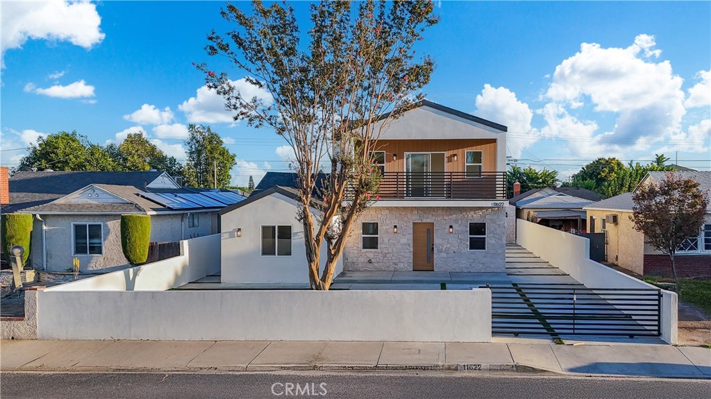 Step into a world of modern sophistication with this newly renovated Norwalk estate, combining style, space, and versatility in one stunning package, offering 2,766 of total living area. The primary residence spans an impressive 2,216 sq ft, meticulously upgraded with new plumbing, electrical, flooring, and a brand-new roof for lasting peace of mind. An inviting, open floor plan awash in natural light leads to three spacious, elegantly appointed bedrooms and bathrooms. The primary suite stands out with nearly 800 sq ft, a luxurious walk-in closet, and a dreamy private balcony perfect for morning coffees or relaxing evenings. Entertain or unwind in the chef’s kitchen, appointed with exquisite Taj Mahal countertops and highlighted by a custom fireplace and detailed Santa Barbara finish with a stylish wood slab façade, making every gathering memorable.
Beyond the main home, discover a fully permitted 550 sq ft ADU featuring two bedrooms and a bath—ideal for guest accommodations, extended family, or generating rental income. The expansive backyard offers abundant space for lively entertaining or quiet alfresco relaxation, further enhancing the property’s appeal. This residence seamlessly blends high-end finishes, thoughtful design, and flexible living options to meet the needs of modern buyers seeking luxury and value in one of Norwalk’s most desirable neighborhoods