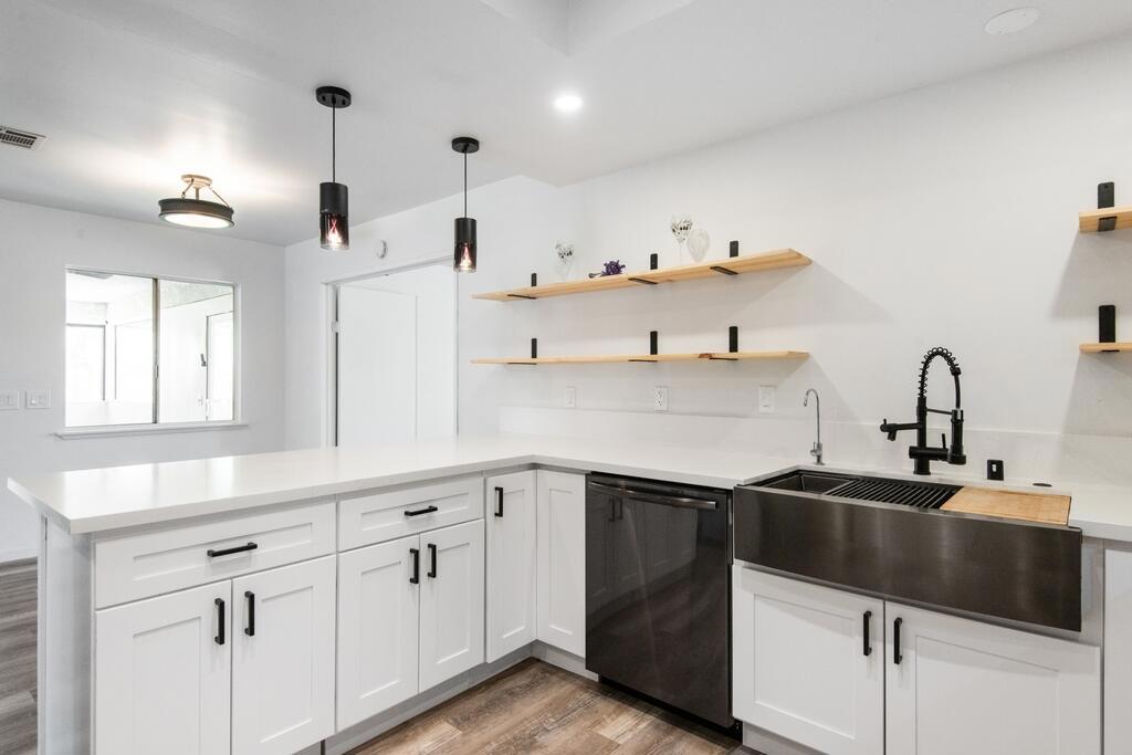 Fully remodeled and move-in ready! This 3-bedroom, 2-bath home offers 1,558 sq. ft. of stylish living space on a 17,000 sq. ft. lot, plus a versatile enclosed patio for use as a guest room, office, or bonus living area. Updates include all-new luxury vinyl plank flooring, fresh carpet in the primary suite, four new mini-splits, a brand-new roof, and updated electrical. The kitchen features new cabinets, quartz countertops, and new appliances. Both bathrooms showcase quartz countertops, designer tile, spa-style sinks, updated plumbing, and anti-fog vanity mirrors with glamorous lighting. Freshly painted inside and out, enhanced by modern light fixtures and a fully fenced yard for added privacy, this home's transformation is complete. Every detail has been carefully considered and updated. Ideally located close to Yucca Valley's shops and dining and just a short drive to Joshua Tree and Palm Springs, this home is ready to be your desert retreat.