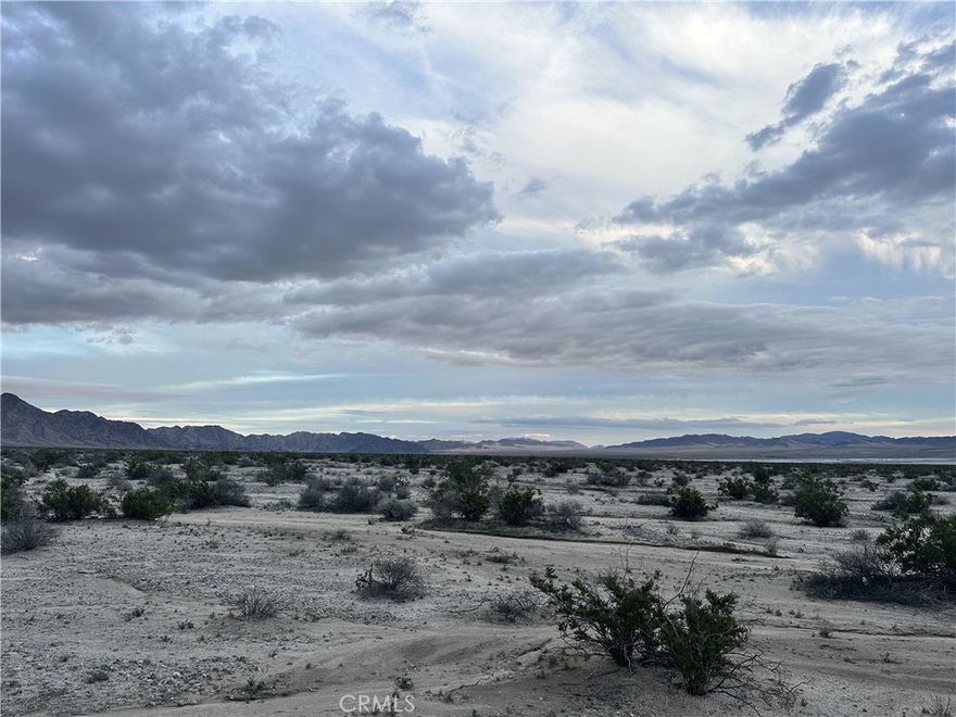 Escape to 15 acres of raw desert beauty in the wide-open expanse of Wonder Valley. Here, you’re surrounded by endless panoramic views, star-filled skies, and the kind of true seclusion that’s getting harder and harder to find. It’s the perfect place for anyone looking to disconnect from the busyness of everyday life and reconnect with the quiet rhythm of the high desert. Despite the feeling of being a world away, this property is less than 30 minutes from downtown 29 Palms, where you’ll find dining, shopping, and essentials. It’s also even closer to the Marine Corps base, adding extra convenience for military personnel or investors seeking proximity to base housing demand. Opportunities for privacy like this are rare—especially on acreage this large. Come experience what New Ironage Rd can offer and imagine the possibilities waiting for you in Wonder Valley.