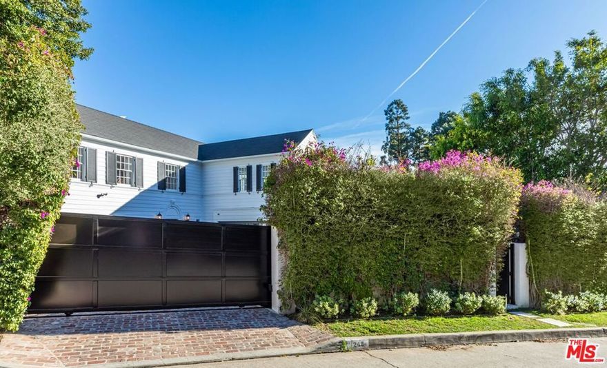 Situated on one of the most coveted streets in the Lower Bird Streets, 1248 N Wetherly is a residence that exudes elegance and sophistication. Beyond verdant hedges and a secure gated drive, this 1936 Traditional offers both classic and modern programming as the ideal retreat from the City. Upon entry, you are greeted by an expansive living room and adjoining family room, drenched in natural sunlight. A renovated gourmet kitchen boasts state-of-the-art Wolf appliances, making it a haven for any culinary enthusiast. The main floor also features a powder bath and a dining room that seamlessly opens up to the large, flat backyard, complete with a pool and spa, built-in BBQ, and a generously sized vintage brick patio - ideal for hosting a large-scale or intimate dinner party. The second floor offers two primary suites, each tastefully designed and meticulously appointed, in addition to a third ensuite bedroom, complete with a private outdoor patio overlooking the pool. While nestled North of Sunset, you are just a short stroll down to The Edition, Soho House, Bird Streets Club, and many more.