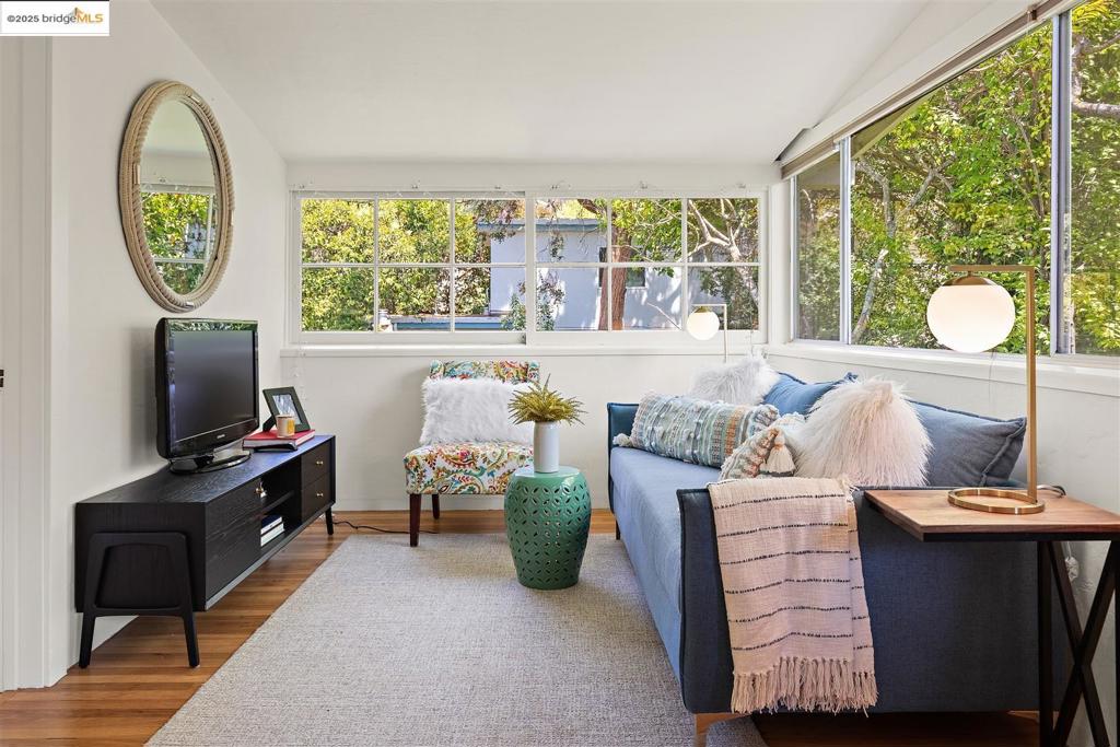 This hip-and-retro Elmwood condo is full of sunshine, style, and unmistakable charm—perfectly positioned on a picturesque tree-lined street, just a short stroll to the shops and cafés of Elmwood and an easy walk to UC Berkeley. Step inside to find a cheerful blend of vintage character and modern updates. The main level features a private bedroom and an open living/dining area bathed in natural light, with leafy treetop views that make every day feel a little more magical. The updated, efficient kitchen keeps things cool with sleek appliances and original exposed brick—a fun nod to its mid-century soul. The showstopper? An Arkle Modular stairway that leads to a lofted hideaway with a roof window offering sweeping views of the hills and Mount Tamalpais—your own private perch for daydreaming, reading, or stargazing. Full of personality, light, and good vibes—this is Berkeley living with a twist.
