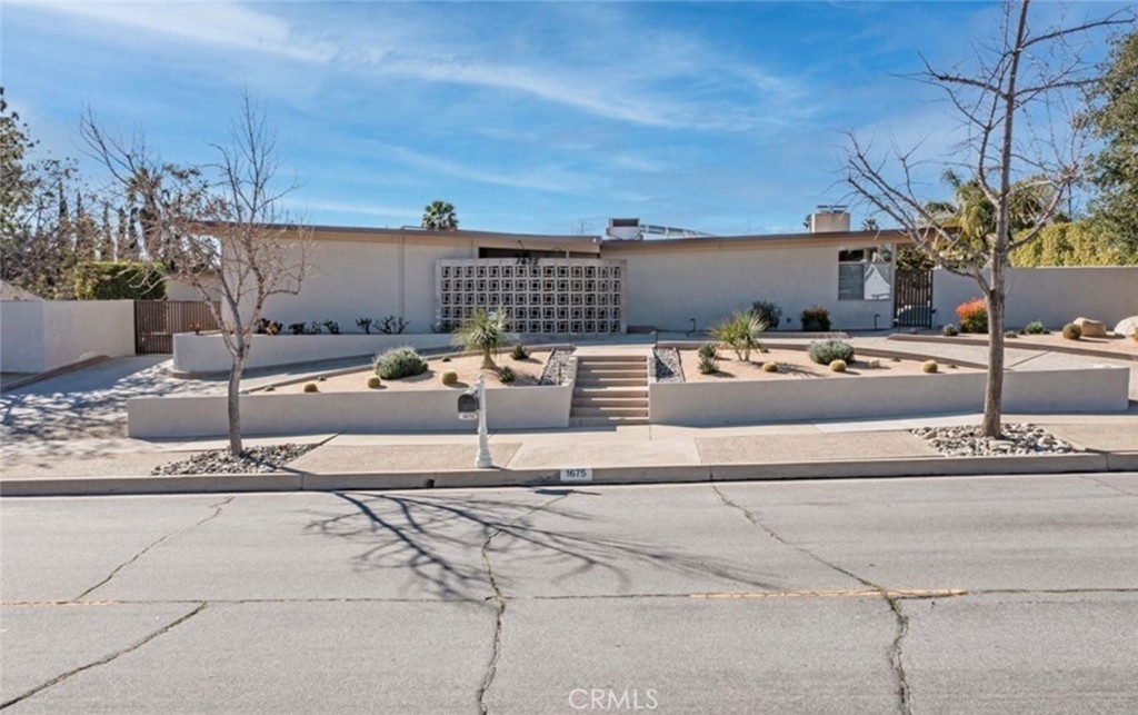 STEP BACK INTO THE ELEGANCE OF THE 1960S WITH THIS BEAUTIFULLY CUSTOM-BUILT MID-CENTURY MODERN HOME. METICULOUSLY MAINTAINED AND THOUGHTFULLY UPDATED, THIS PROPERTY CELEBRATES ITS ORIGINAL CHARM WHILE INCORPORATING TASTEFUL MODERN ENHANCEMENTS.
FROM THE MOMENT YOU ARRIVE, YOU'LL APPRECIATE THE RESTORED CUSTOM CABINETRY AND WELL-PRESERVED VINTAGE BATHROOMS THAT ECHO THE HOME'S ORIGINAL CRAFTSMANSHIP. THE KITCHEN FEATURES GRANITE COUNTERTOPS, STAINLESS STEEL APPLIANCES, AND BLENDS SEAMLESSLY INTO THE AESTHETIC WITH NEW WOOD FLOORING FLOWING THROUGHOUT THE MAIN LIVING AREAS.
THE SPACIOUS LAYOUT OFFERS OVER 2,800 SQUARE FEET OF LIVING SPACE, INCLUDING A FORMAL LIVING ROOM WITH A STRIKING ORIGINAL PETRIFIED WOOD FIREPLACE AND A LARGE SUNROOM/BONUS ROOM WITH A SECOND MATCHING FIREPLACE—PERFECT FOR RELAXING OR ENTERTAINING.
FLOOR-TO-CEILING WINDOWS INVITE NATURAL LIGHT AND SHOWCASE STUNNING VIEWS OF THE EXPANSIVE, HALF-ACRE BACKYARD. DESIGNED WITH GATHERINGS IN MIND, THE OUTDOOR SPACE INCLUDES A SALTWATER POOL WITH A SPILL-OVER SPA, A NEWLY INSTALLED SAFETY GATE, A TWO-LEVEL PATIO WITH BUILT-IN FIRE PIT, PUTTING GREEN, AND MATURE FRUIT TREES—PLUS DROUGHT-TOLERANT LANDSCAPING FOR LOW-MAINTENANCE BEAUTY.
THIS HOME ALSO OFFERS EXCEPTIONAL GARAGE SPACE: TWO 2-CAR GARAGES (ONE ATTACHED, ONE DETACHED), AN RV GARAGE WITH HOOKUPS, AND A GATED COURTYARD FOR ADDITIONAL PARKING OR STORAGE. THE DETACHED GARAGE FEATURES HVAC AND A BATHROOM, WHILE THE ATTACHED GARAGE INCLUDES AN UPSTAIRS OFFICE OR STORAGE SPACE. ALL GARAGE FLOORS HAVE BEEN PROFESSIONALLY REFINISHED.
PAID-OFF SOLAR ADDS VALUE AND EFFICIENCY, AND ORIGINAL ARCHITECTURAL PLANS ARE INCLUDED—OFFERING A RARE OPPORTUNITY TO OWN A HOME WITH BOTH CHARACTER AND FUNCTIONALITY.