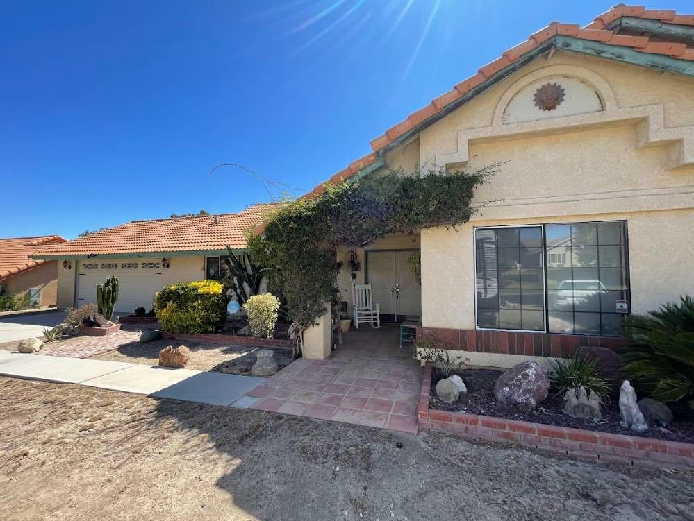 Nestled on a generous 1.2-acre lot in a peaceful Palmdale neighborhood, this charming traditional-style residence offers 4 bedrooms and 2 full bathrooms within its 2,051 square feet living space. The property also offers convenient RV access, a long driveway, and a spacious two-car garage. With its expansive, level grounds and serene surroundings, it’s ideal for those seeking both space and tranquility.