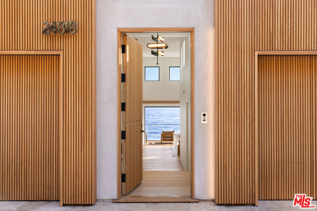 Completely remodeled contemporary oceanfront home done by Babineau Construction on world-renowned Malibu Rd. The house sits on a rare 60 feet of ocean frontage. With sweeping coastline and island views, this 4 bedroom, 4.5 bathroom home is designed with thoughtful attention to detail throughout. The interior features custom white oak cabinetry and plastered walls. The open plan living room and dining room include a bespoke separate bar area. The extensive primary suite runs the length of the home and includes a large bathroom, and expansive walk-in closet. The 60-foot deck that stretches along the soft sand of Malibu Rd is an entertainer's dream. There is dedicated surfboard storage and outdoor shower. This prime Malibu location is close by to SoHo house and Nobu, and just a short drive to Santa Monica.