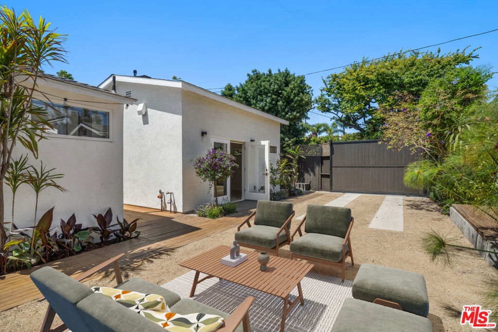 Welcome to 2425 Cloy Ave a beautifully reimagined 3 bed, 3 bath modern bungalow nestled in the coveted Silver Triangle. This gated and ultra-private residence offers lush, mature landscaping in both front and rear yards, creating a tranquil retreat just steps from the iconic Venice Canals, Abbot Kinney, and the shops and restaurants of Marina del Rey. Step inside to a sun-drenched interior with crisp white walls and rich hardwood floors, delivering a clean, coastal aesthetic throughout. The open-concept layout seamlessly connects the living, dining, and kitchen spaces, while tastefully renovated bathrooms and a sleek, modern kitchen offer both style and functionality. The crown jewel? A permitted ADU with soaring ceilings, custom French doors, built-in storage, full bath with shower, and its own HVAC system ideal as a home office, guest suite, or creative space. This is Venice living at its finest turnkey, sophisticated, and undeniably cool.