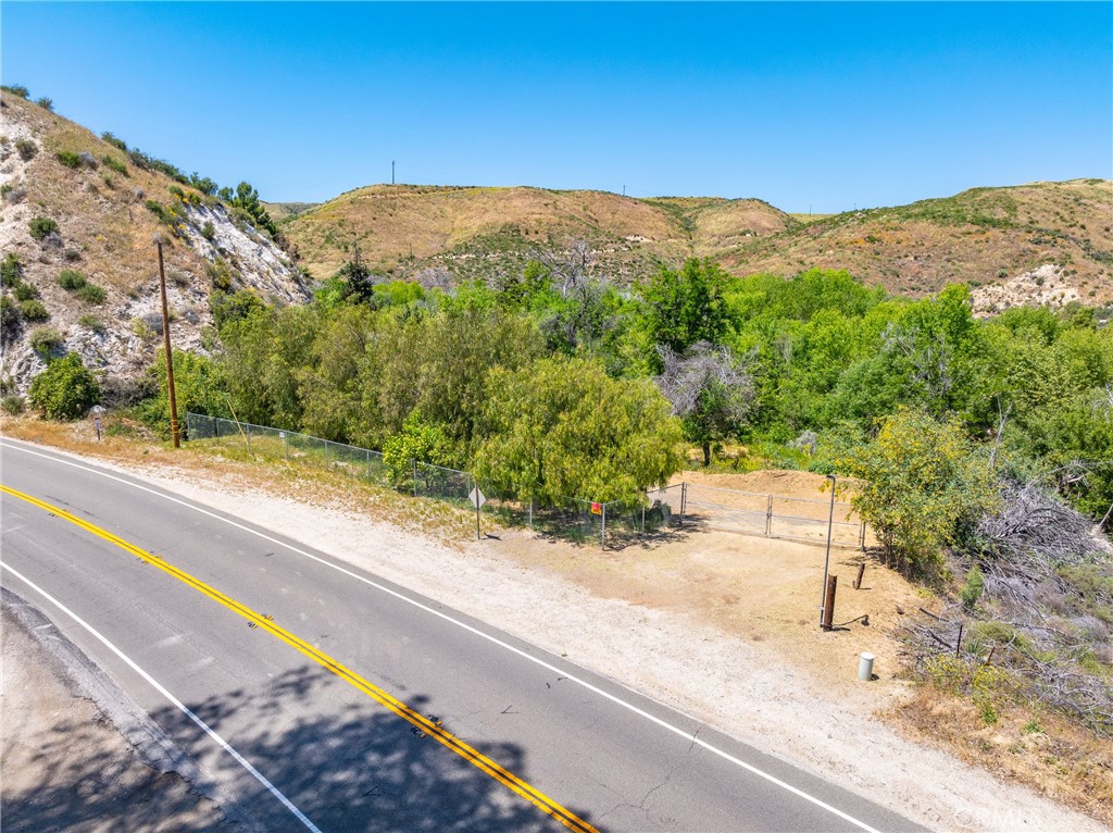3.489 Acres in Acton. Secluded while also convenient proximity to Santa Clarita, Palmdale and just 30 miles to San Fernando. Partially developed with space for an RV, water well, and a power pole at the street. Beautiful views of the Santa Clara Riverbed and trees at the back of the property.