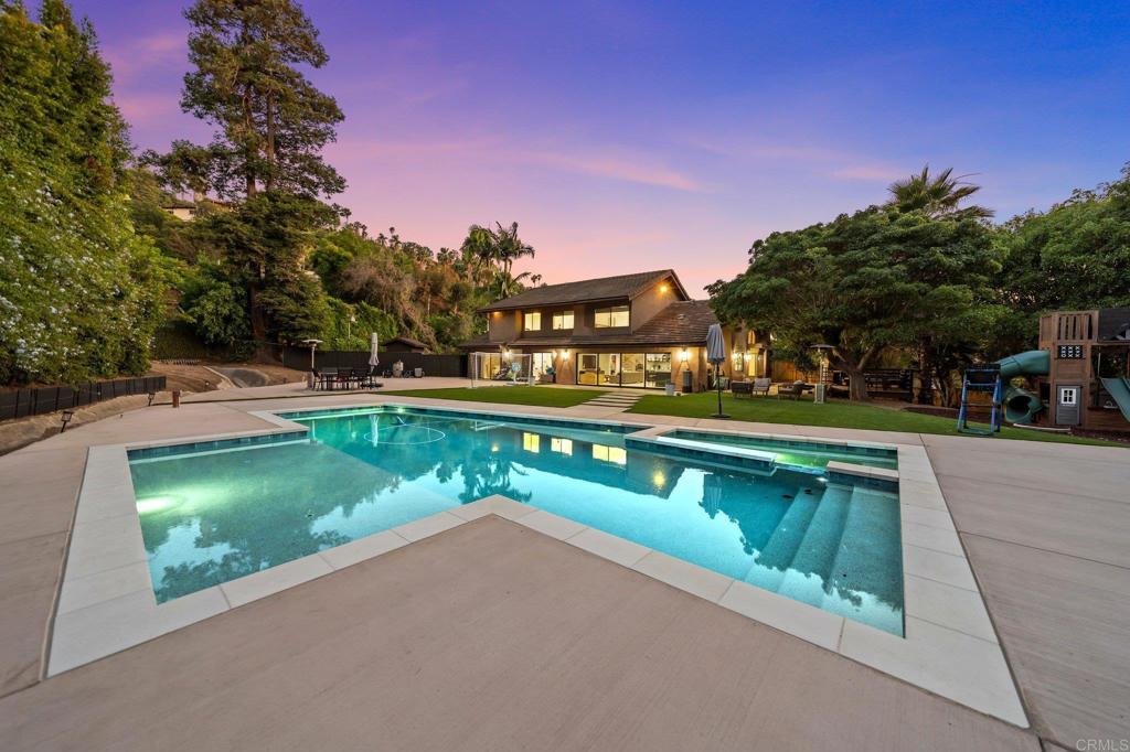 Welcome to your dream home in the heart of La Mesa, nestled in an exclusive gated community offering privacy, luxury, and an unparalleled lifestyle. This stunning 5-bedroom + an office, 4-bath residence has been meticulously remodeled with high-end finishes and modern amenities throughout. The open-concept floor plan seamlessly blends indoor and outdoor living, with expansive living areas that flow into a chef-inspired kitchen featuring marble countertops, premium Thermador appliances, a steam oven, a spacious pantry, and a state-of-the-art Zip water system. Designed with the entertainer in mind, the backyard is a true oasis—complete with a private heated pool, lush landscaping, and multiple lounging areas perfect for gatherings. The home also boasts a rare 6-car garage, ample storage space, and fully owned solar for energy efficiency. Light-filled rooms are adorned with elegant RH lighting fixtures and durable luxury vinyl flooring, while large windows capture serene lake views. Enjoy resort-style living with access to community amenities including a fishing lake, tennis courts, playground, and pool—all just minutes from top-rated schools, shopping, and dining. This exceptional property offers a rare opportunity to experience sophisticated Southern California living at its finest.
