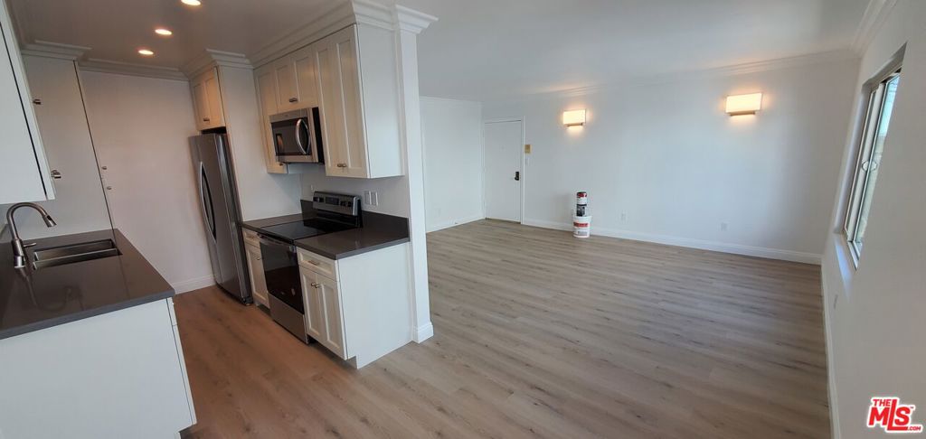 Completely renovated from top to bottom. This 2 bedroom, 2 full bath apartment is on the top floor, centrally located near shopping on Lincoln at 12th and Michigan greenway, near three well-regarded SMMUSD schools, walkable to Santa Monica College. Bike share station within 50 feet. Modern kitchen with dishwasher, garbage disposal, microwave, refrigerator. Electric fireplace with architectural stone chimney in large living room. Very private and quiet. Rent controlled. Two covered parking spaces (tandem) with storage space. Convenient community laundry room on site . Water, hot water, and trash paid by owner. Very spacious and comfortable. Shown by appointment.