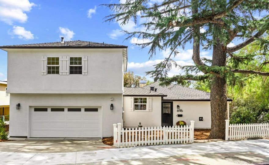 Set atop of Augusta Ct, a private cul-de-sac next to Vasona Park & minutes from downtown, 696 N Santa Cruz Ave is a beautifully extended residence that blends charm, comfort, & convenience in one must-see package. See photo for 7 assigned parking spots - use for open house, or park on Bruce Ave. There are three naturally light-filled bedrooms on the main level, refinished oak floors, a welcoming living room with fireplace, & French doors opening to the outdoors. The custom kitchen with granite counters & bespoke cabinetry is designed for both everyday living & entertaining. Upstairs, the expansive primary suite offers cathedral ceilings, newly refinished heart-of-pine wide plank floors, a chandelier, spa-like bath with separate shower & WC, walk-in closet, & a covered balcony with sweeping views of Vasona Park, the Los Gatos Hills, & beyond. Outdoors, Spanish-style steps lead to a secluded tiled patio, an inviting setting for gathering, dining, & enjoying life year-round. Mature landscaping & fruit trees frame the space, while a two-car garage with extra storage plus seven additional designated parking spaces add practicality. Top Los Gatos schools & Vasona Park moments away, & downtown dining & shopping this home combines space, privacy, & convenience in the heart of Los Gatos.