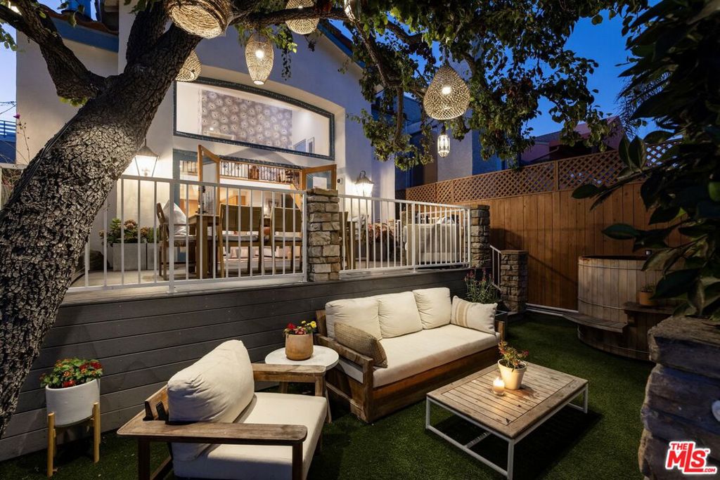 Welcome to 439 Carroll Canal, a stylish contemporary Mediterranean home with exceptional design and a multitude of updates set on the iconic Venice Canals. Featuring an open floor plan, expansive windows, and vaulted ceilings, the interiors are filled with natural light and flow seamlessly between the living, dining, and kitchen areas. The chef's kitchen with bar seating is designed for both casual gatherings and effortless entertaining, while the living room is anchored by a chic stone-surround fireplace and opens through French doors to a spacious deck with a recently installed gourmet BBQ, perfect for outdoor dining. Upstairs, two grand bedrooms each offer recently updated luxurious en-suite bathrooms and walk-in closets. A light-filled loft perched above the living room provides the perfect setting for a home office or lounge space. Outdoor living is highlighted by a two-tiered yard with the large main deck and a lower-level retreat space featuring upgraded turf. Unwind in the soothing cedar soaking tub, also one of the many newer upgrades. At night, twinkling pendant lights strung through canopy trees illuminate the grounds, creating a romantic and enchanting atmosphere. A dock with a pontoon-style boat completes the ultimate canal lifestyle. With a two-car garage plus parking for two additional vehicles, the home offers rare convenience in the canals. Its north-side location maximizes walkability to shops, restaurants, and the vibrant energy of Abbot Kinney.
