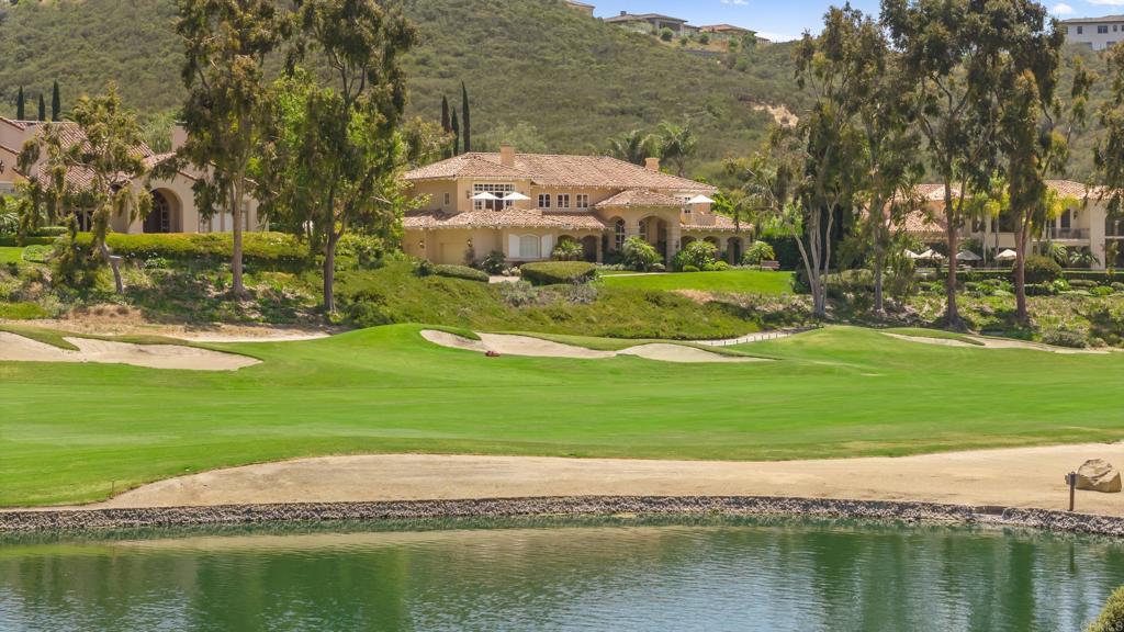 Welcome to 6369 Clubhouse Drive, a sophisticated and fully modernized estate available for rent within the prestigious gated community of Del Mar Country Club. This bright and spacious residence features floor-to-ceiling windows throughout, offering stunning views of the golf course and pond at the front and serene vistas of a nature reserve at the back. Designed for comfortable family living and elegant entertaining, the home's floorplan provides seamless flow for gatherings large and small. Residents will enjoy one of the largest and most meticulously landscaped gardens within DMCC, highlighted by a luxurious pool and cascading waterfall, creating a private resort-style ambiance. The home is offered turn-key with optional high-end furnishings from distinguished Italian, German, and American designers. Recent upgrades include beautiful new wood flooring, an automated chlorine-free spa and pool system, automated garden irrigation, and sophisticated garden illumination. The chef’s kitchen is fully equipped with brand-new premium appliances, including a Subzero fridge/freezer, Wolf range, Thermador double wall oven, microwave, warming drawer, and dual dishwashers. Additional conveniences include an LG laundry suite, an advanced solar power system providing exceptional energy efficiency, upgraded HVAC with heat pumps, comprehensive whole-house water filtration, and ultra-fast CAT6a wiring for optimal connectivity. Safety features surpass current homeowner insurance standards with extensive fire-prevention upgrades, including a dedicated fire pump, amber-resistant vents, seismic earthquake gas shut-off, automated water leak detection, and a fully integrated sprinkler and security system. Located in the highly desirable Torrey Pines High School district and close to beaches, farmers' markets, upscale shopping, and fine dining, 6369 Clubhouse Drive offers unparalleled luxury and convenience for discerning tenants seeking the finest Southern California lifestyle.