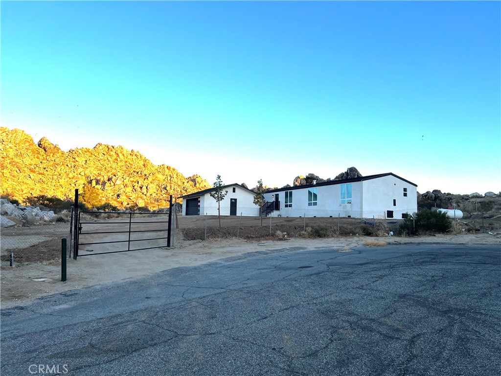 Tucked away on a private 0.88-acre lot in the heart of Lake Los Angeles, this beautifully remodeled 3-bedroom, 2-bath home and offers the perfect blend of modern upgrades and desert serenity. Inside, you'll find fresh laminate flooring throughout, updated bathrooms with tile floors, and a contemporary kitchen featuring stainless-steel appliances, including a stove, dishwasher, and microwave hood. The spacious living room boasts a cozy wood-burning fireplace, while new windows, fresh interior paint, a brand-new roof, and heating and air conditioning units ensure comfort and style. The detached 2-car garage is finished with Reeses lights, offering additional space for storage or a workshop. This home is a true desert oasis—private, peaceful, and move-in ready, with all the upgrades you need for modern living!