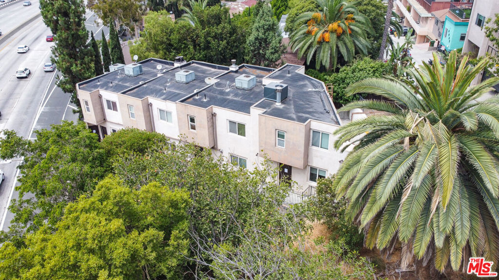 A unique Whitley Heights musicians' dream, located just around the corner from the Hollywood Bowl. Built in 2006, four of the units include large separate and private spaces (up to 400 sq ft.) currently used as music studios. This well-maintained 5-unit property offers a mix of: one (1) low-income one-bedroom/one-bathroom unit, one (1) standard one-bedroom/one-bathroom unit, and three (3) two-bedroom/two-bathroom units. The spacious townhome-style units feature hardwood floors, natural light, large closets, and private bathrooms. All units are equipped with central HVAC, stoves, refrigerators, and dishwashers. The 2-bedroom units also feature in-unit washer/dryers. Additional amenities include a separate on-site laundry room for the 1-bedroom units, a fenced rear yard suitable for outdoor gatherings, hillside views of Hollywood, and on-site covered parking. Tenants pay all utilities except for community lighting and laundry room utility charges. Great central Hollywood Hills location with strong demand makes this an ideal addition to your portfolio.
