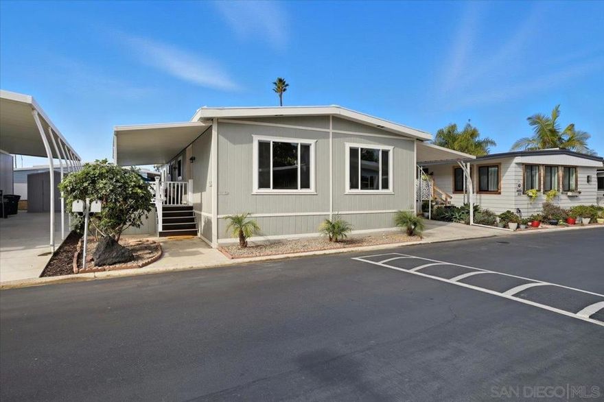 This Modern Coastal Home blends contemporary comforts and aesthetics with a coastal, relaxed atmosphere.  Soothing gray colors, large open spaces, solid surface flooring throughout. Well-appointed kitchen, with ample work space and an expansive island, has newer appliances w/5 burner gas stove. Primary bath is thoughtfully modernized w/double vanity & a wall to wall shower!   24'X8' deck perfect for entertaining and spacious, pet friendly, fully fenced lower yard w/artificial turf. **No Property Taxes**  Location is a 10 minute walk to South Carlsbad State Beach! LARGE strip mall offers EVERY POSSIBLE amenity from shopping to services all just a walk across the street! Lakeshore Gardens has a multitude of community areas that are upscale, assessible and beautiful!