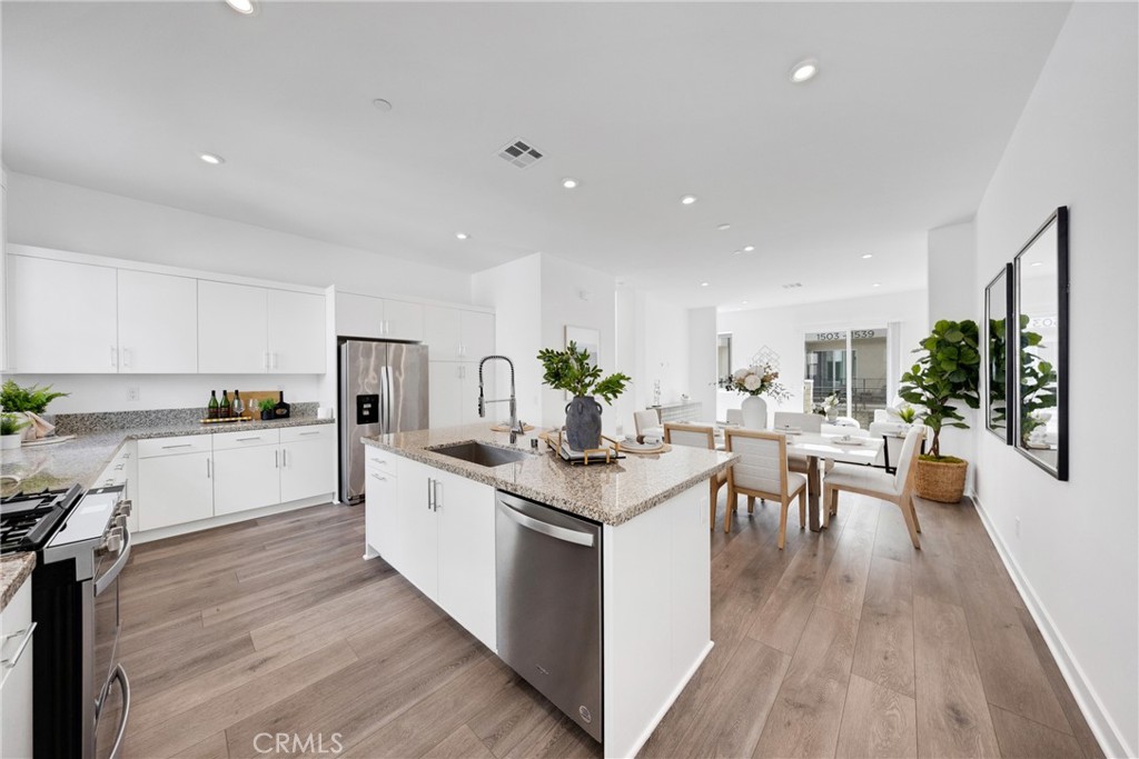 Beautifully upgraded condo featuring 3 bedrooms and 3.5 bathrooms in an open and versatile floor plan. The main living level on the second floor includes a spacious great room, dining area, and a modern kitchen equipped with quartz countertops, stainless steel appliances, and an oversized island perfect for gatherings. A powder room adds convenience for guests. The primary suite occupies the third floor and offers a generous walk-in closet and a stylish en-suite bathroom. Additional highlights include an attached two-car garage, interior laundry area, and energy-efficient solar panels. Enjoy community amenities such as a swimming pool and park. Conveniently located near Disneyland, shopping centers, restaurants, and major transportation hubs.