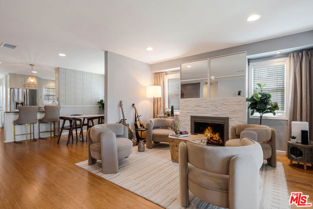 Beautifully designed 3-bedroom home in the heart of Westchester with an open floor plan and thoughtful updates throughout! Step inside to a bright living area with recessed lighting and a cozy fireplace, flowing seamlessly into the kitchen and dining area. The kitchen features stainless steel appliances, bar seating, and large windows provide excellent natural light. A full bathroom with shower-over-tub sits off the kitchen, along with two spacious bedrooms offering sliding closets and ample storage. The primary suite includes an en-suite bath with a double vanity, separate shower and tub, plus double doors that open to a private backyard retreat. Toward the rear of the home, a bonus room with a half bath and backyard access makes the perfect space for entertaining, a home office, or guest use. Additional highlights include a long driveway with room for multiple vehicles and a garage that can easily serve as a gym or creative workspace. Located West of Lincoln Blvd, and just moments from Playa Vista, LMU, LAX, and an array of shops and restaurants, this home offers both comfort and convenience in a highly sought-after neighborhood.
