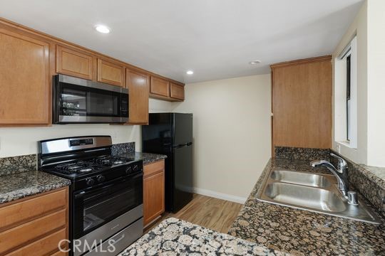 Beautiful two bedroom condo with open floor plan located in gated Palmilla Community. Kitchen features granite counter tops and brand new stainless steel appliances. Other features include brand new stainless steel double sink and disposal. Kitchen opens up to the dining room and spacious living room. Balcony with views is located off living room area for a cozy outside area. Both bedrooms are spacious with plenty of closet space. Bathroom features granite counter tops and a powder room vanity area with sink. Vinyl wood flooring throughout and new paint. This open flowing floor plan creates an abundance of natural lighting and home also has a detached one car garage with storage. The community is safe and gated. Perfect for first time buyer or investors. Located near UC Riverside, freeways, shopping and dining. Completely turnkey! This one will not last!
