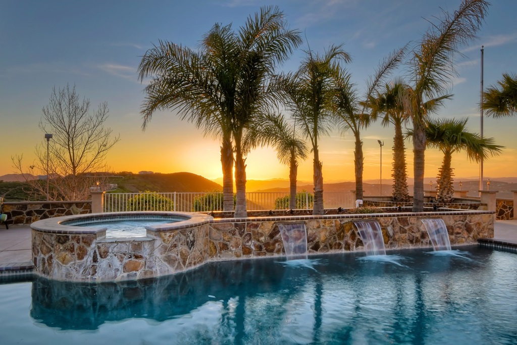 Executive Estate on 15+ areas of scenic land. From the moment you walk thru the doors you’ll feel like you’re in your very own resort. The 3000 sq ft main house boasts an open floor plan concept with 10 ft. ceilings, spacious bedrooms, large kitchen, formal dining, office/craft room and lots of storage. The views from every room are breathtaking! You’ll experience 360 degrees of mountain and city views full of colorful peaceful skies. For additional details please review supplemental section. This custom home is truly a must see! There’s so much to offer! The interior has high end finishing touches and the wood flooring are gorgeous. Bedrooms are over-sized with large closets and high ceilings allowing for lots of natural lighting. Builder perfectly placed the kitchen in the center of the home with large viewing windows, tons of cabinets and ample counter space for cooking. Step outside into a private oasis. The sparkling pool, warm bubbly spa, propane fire torches, spacious sitting areas, outdoor lighting for ambiance, BBQ area, and the most amazing sunsets you’ll ever see. There’s plenty of space for large parties and the perfect venue for special events. The 1000 sq ft detached pool house with patio bar area can either house as a studio or a hub for poolside entertaining. It’s complete with a large upgraded kitchen and bathroom facilities. This property is perfect for multi family living or potential rental income. The 1200 sq ft 2 bedroom, 1 bath detached guest house is located on the lower section providing privacy and it’s own yard space. Great rental potential (roughly $2500 monthly rent) or good for a multi generational family. Also, If you’re looking for a large work shop, RV parking and lots of garage/storage space, you’ve found it! Property is zoned A72 with an “O” animal designater. There’s plenty of room for a Vineyard, Equestrian Facility, Orchards, Outdoor Recreation and more. There’s even a designated private gun and archery range. If you’re worr...