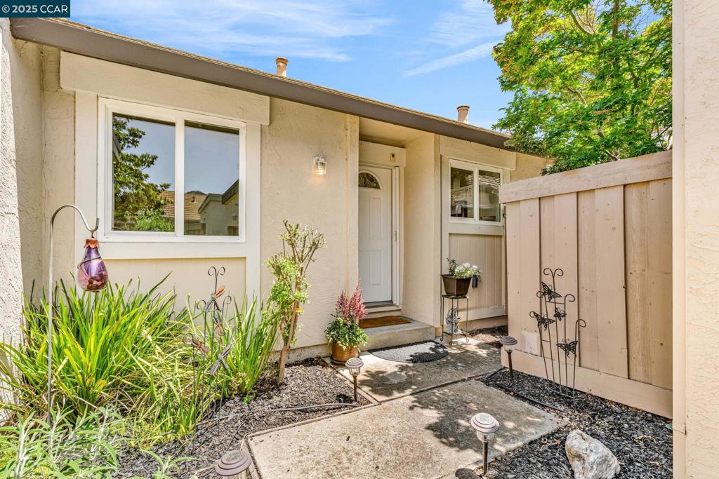 Spectacular single story end unit brimming with style and sophistication! Coveted neighborhood with a stunning surround of stunning Mt Diablo views! Splashed in natural light with vaulted ceilings, the spacious living room offers a cozy wood burning fireplace, laminate flooring, new light fixtures, and walls of windows looking out to the sunny patio. Kitchen features include white cabinetry, solid surface counters, stainless steel appliances and designer black hardware. boasting vaulted ceilings, ample closet space and sliding French doors to the quiet back patio, the primary bedroom is a tranquil retreat. The updated bathroom has a newer vanity, stall shower and newer hardware and fixtures. A convenient office/3rd bedroom is situated in the middle of the unit and looks out to the quiet front courtyard. An attached two car garage is spacious and has laundry hook ups and storage space. Sunny and tranquil, the back deck is perfect for entertaining or romantic and elegant meals al fresco. This sought after location offers stunning views of Mt. Diablo and is just steps to the picturesque community swimming pool, scenic trails, and convenient proximity to charming downtown shopping and restaurants.