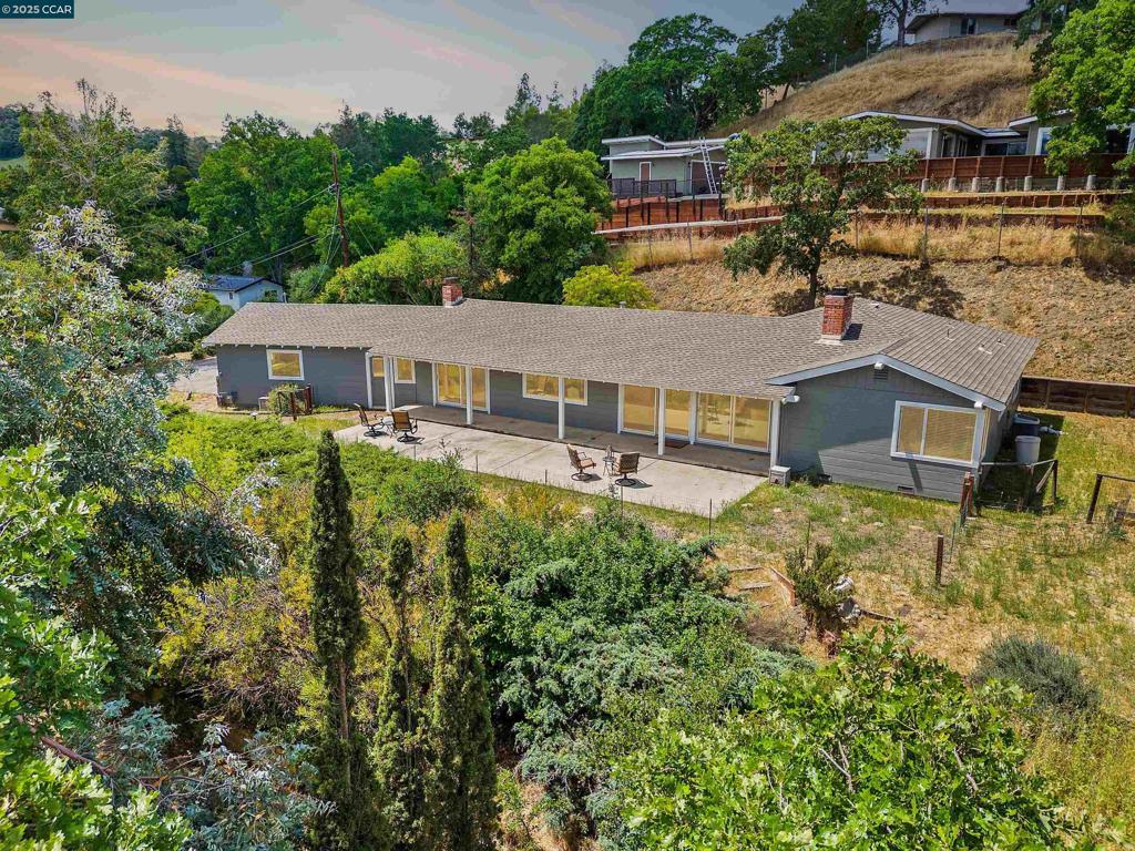 A rare opportunity to own .93 acres with enormous possibilities in Walnut Creek’s desirable & scenic Tice Valley. Private & peaceful location. Front garden entry. Profit from the fabulous potential to lot split this acreage. Build an income-producing ADU, a guesthouse, or expand the existing 1739+/-SF ranch-style home. Take advantage of panoramic & east-facing Mt. Diablo views at the top of the tree-lined driveway. 3 bds. 2 bths. Dramatic vaulted exposed redwood beam & tongue & groove ceilings, tile flrs, fresh interior paint, wood blinds, new light fixtures. Multiple storage closets. Formal living rm w/wood-burning frpl & slider to backyard patio & outdoor gardens, mature trees, raised bds, views. Adjacent dining rm enjoys views through wall of windows. Galley-style kitchen, granite slab counter, peninsula island. Family rm & casual dining area w/slider to bkyd. Primary suite w/hillside, treetop views, large reach-in closet. En suite w/shwr, pedestal sink. 2 more bdrm w/reach-in closets, garden view windows. Oversized 2-car garage, storage, workbench. Off-street parking for multiple cars. Front-loading washer/dryer, utility sink. Easy access to Iron Horse Trail, top-rated Walnut Creek schls, freeways, BART. 1 mile to downtown Walnut Creek, Broadway Plaza, restaurants.
