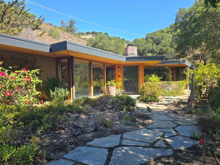 Gated, private, tranquil, and timeless, a unique custom Adobe home that is located in the heart of beautiful Carmel Valley village. This sophisticated architectural gem is nestled among patio gardens with mature trees and majestic Valley Oaks in a peaceful setting that is bathed in natural beauty. This 2,312 square foot single level home is light and bright with two spacious bedroom en- suites. A stunning golden granite entry leads to a light, bright and spacious central great room that is open and flowing to the living, dining, family room, gourmet kitchen and walk-in pantry. This timeless mid-century home features wonderful craftsmanship and amazing details, while retaining its wonderful original Adobe and redwood charm and character. The master suite is spacious and sublimely tranquil; it features vaulted ceilings, skylights, walls of glass, a cozy wood burning fireplace, spa-like master bathroom, walk in custom closet, and views of the private patio. Perfect as your main residence or weekend getaway, stroll to restaurants, wine tasting and enjoy the true essence of Carmel Valley village lifestyle with 300 days of sunshine, this inspiring Zen-like setting is a wonderful place to relax and call home.