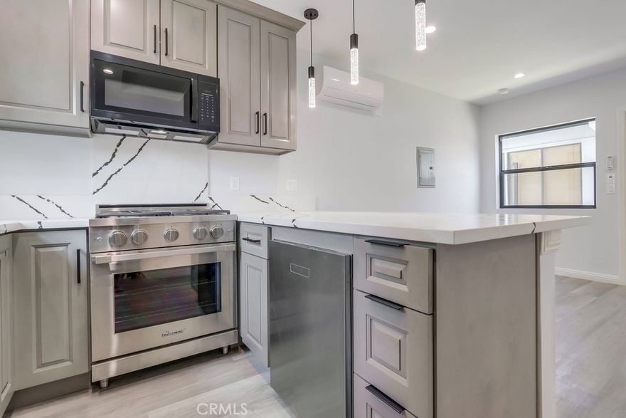 Welcome to 1260 E Turin Avenue "Unit B" — a modern, detached ADU privately located at the rear of the property with its own gated entrance, paved front area, and private back patio. This thoughtfully designed 1-bed, 1-bath unit features a bright, open layout with high-end finishes and appliances throughout. The sleek kitchen includes marble-patterned counters with black veining, soft grey cabinetry, matte black fixtures, pendant lighting, and bar seating—plus premium appliances and a stacked washer/dryer included. The spacious bedroom offers natural light and sliding glass door access to the private patio, while the full bath showcases upscale tilework and dark modern accents for a cohesive, designer look. Ideal as a guest suite, rental, or flex space, this stylish unit offers comfort, privacy, and functionality—just minutes from the Anaheim Packing District, Disneyland, and Angels Stadium