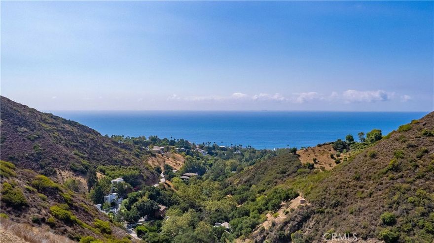 Discover a rare gem in Malibu’s breathtaking landscape! This stunning 8-acre private lot, just a mile from the iconic shoreline, boasts jaw-dropping ocean views that inspire dreams. Previously approved plans envision a sophisticated 4,350 sq. ft. single-story masterpiece designed to capture every shimmering wave, yet the possibilities are endless. The expansive, flat home-site pad invites you to create an even grander estate or dual residences. Remnants of a former home offer solid concrete footings, perfect for a basement or wine cellar, adding character to your vision. A gentle seasonal stream weaves through lush, mature trees and vibrant landscaping, creating a serene oasis. As a delightful bonus, a charming small home and storage space provide convenience during construction or a cozy retreat. Don’t miss this once-in-a-lifetime chance to craft your legacy in the heart of Malibu’s majestic beauty—act fast!