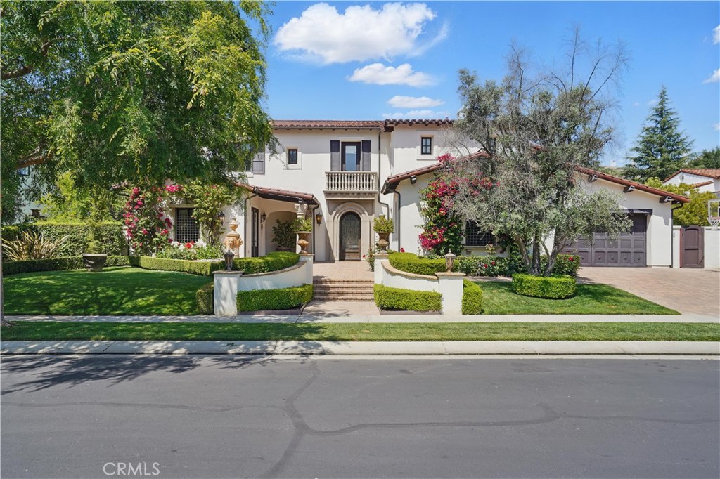 Welcome to The Oaks of Calabasas, where luxury meets lifestyle in this beautifully updated modern Mediterranean estate, located on a peaceful cul-de-sac. This rare Laing Castille Plan 2 spans approximately 6,704 sq ft and features 6 en-suite bedrooms and 7 bathrooms, offering both elegance and functionality. The grand entry showcases soaring double-height ceilings, cathedral-style architecture, and a dramatic spiral staircase. The formal sitting room flows into a custom-designed office and a stunning, temperature-controlled wine wall with capacity for over 1,200 bottles. The chef’s kitchen is the heart of the home, featuring Calacatta marble on the oversized island, top-of-the-line Wolf and Sub-Zero appliances, a butler’s nook, and a spacious walk-in pantry. A seamless layout leads to a state-of-the-art movie theater equipped with built-in high-end audio/visual components, leather reclining seats with cup holders, and cell phone charging ports. An additional bonus room adds flexibility for entertaining or relaxing. Upstairs, the expansive primary suite is a private retreat with two sets of French doors that open to a large balcony overlooking the pool. The suite is complete with dual custom walk-in closets and a luxurious spa-like bathroom. The lush, resort-style backyard is designed for year-round indoor-outdoor living, featuring a covered gazebo with a fireplace, lounge area, bar, and built-in BBQ. A separate alfresco dining space overlooks the one-of-a-kind saltwater pool and spa with cascading waterfalls and dramatic water features, a solar pool heater and a large sauna. Additional amenities include a whole-house sound system, water softener filtration system, a finished 3-car garage with epoxy flooring and EV hookups, and an assortment of mature fruit trees. Residents of The Oaks enjoy 24-hour guard-gated security, patrol service, tennis courts, a newly renovated gym, Olympic-sized pool, clubhouse, playground, and miles of scenic hiking trails—just minutes from premier shopping and dining. This is a truly custom, one-of-a-kind home offering the ultimate in California luxury living.